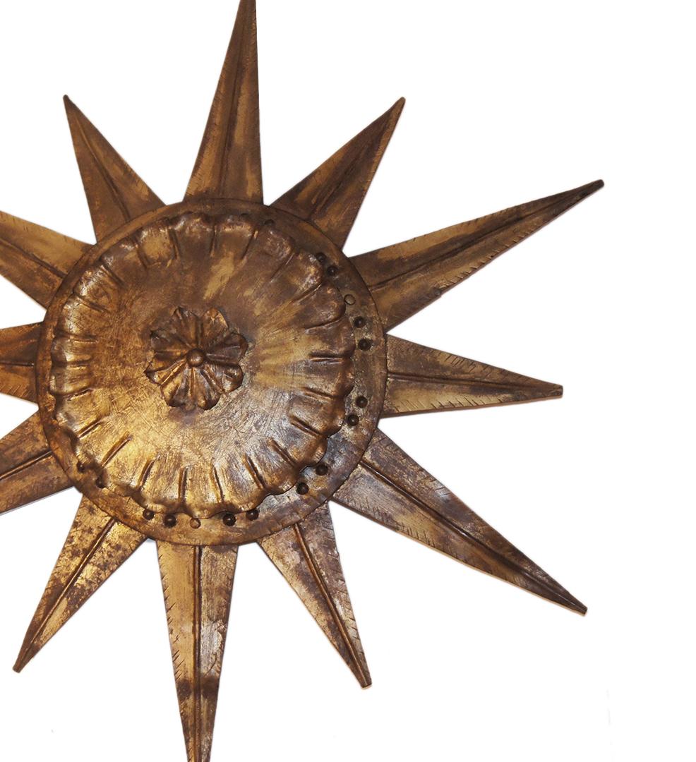 A circa 1940's French hammered metal star/sunburst shaped pendant light fixture with 4 interior lights.

Measurements:
Diameter: 30