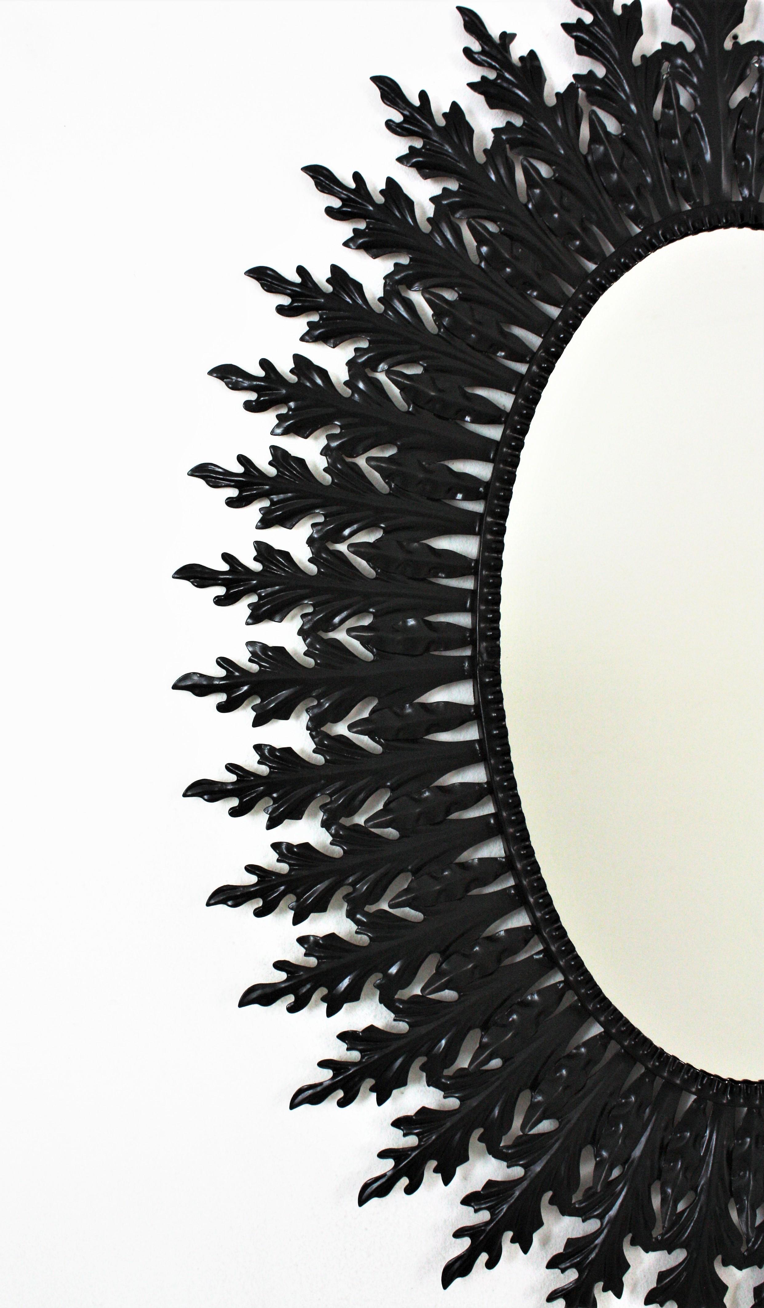 Grand miroir ovale Sunburst en fer laqué noir Bon état - En vente à Barcelona, ES