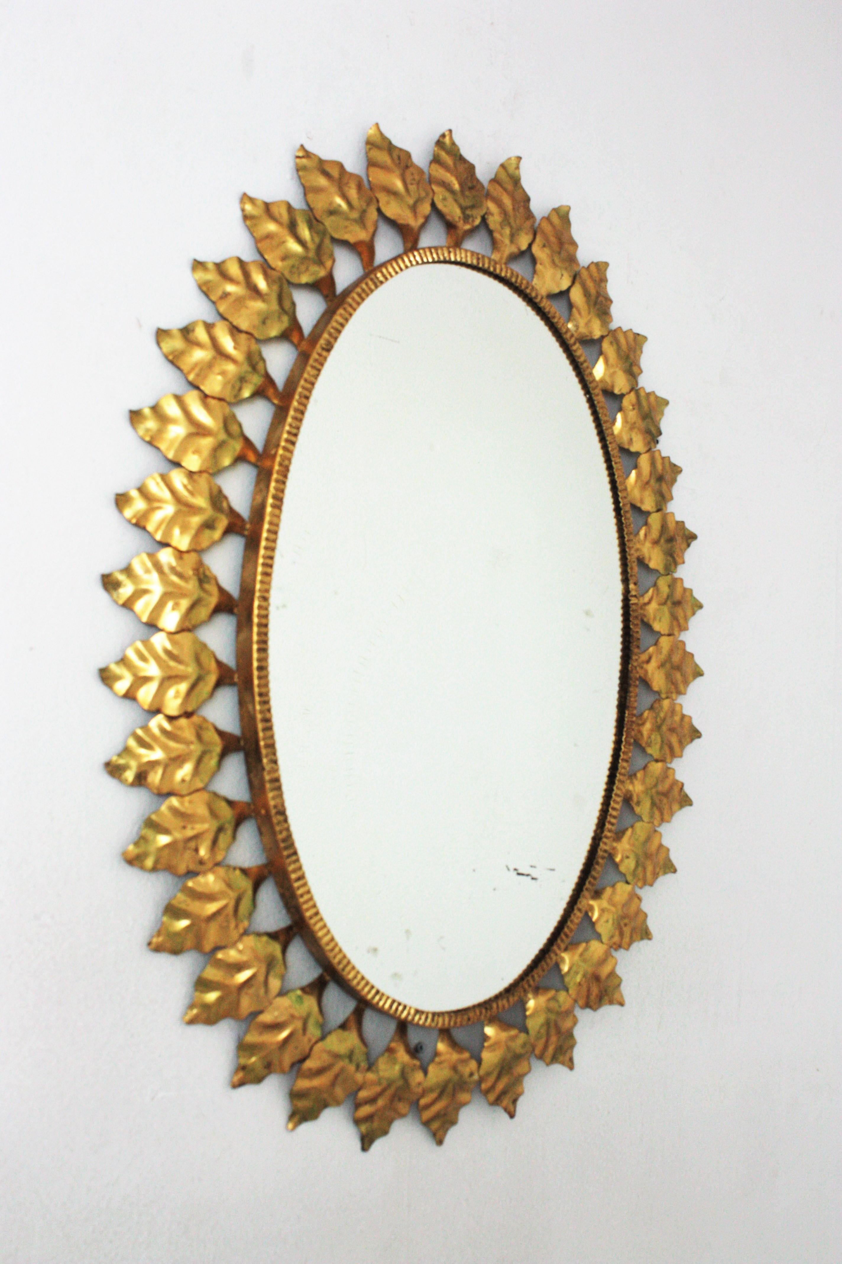 Ovaler Spiegel mit Sonnenschliff aus vergoldetem Eisen, 1950er Jahre (Spanisch) im Angebot