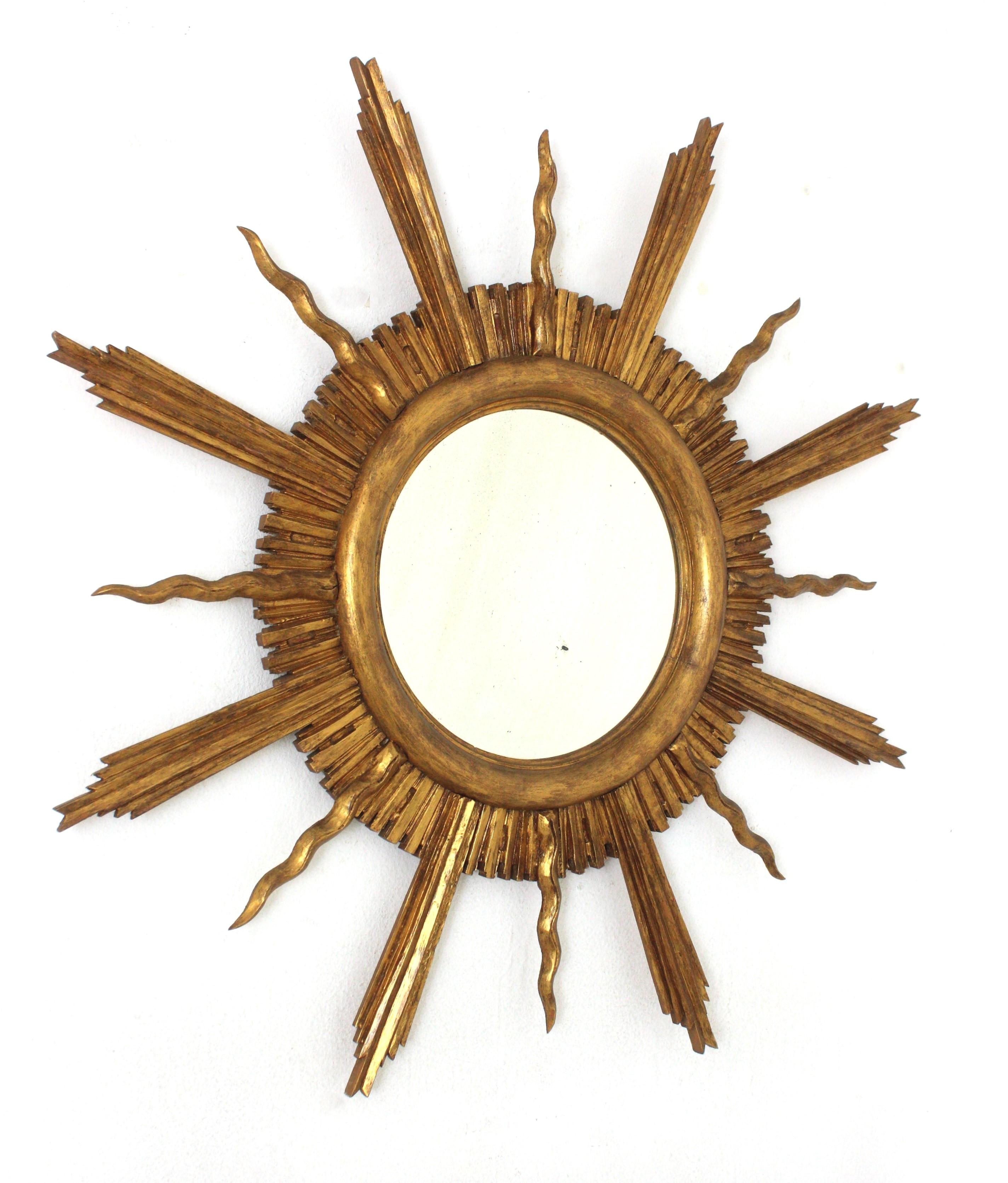 Neoclassical Large Sunburst Starburst Giltwood Mirror in the Style of Gilbert Poillerat For Sale