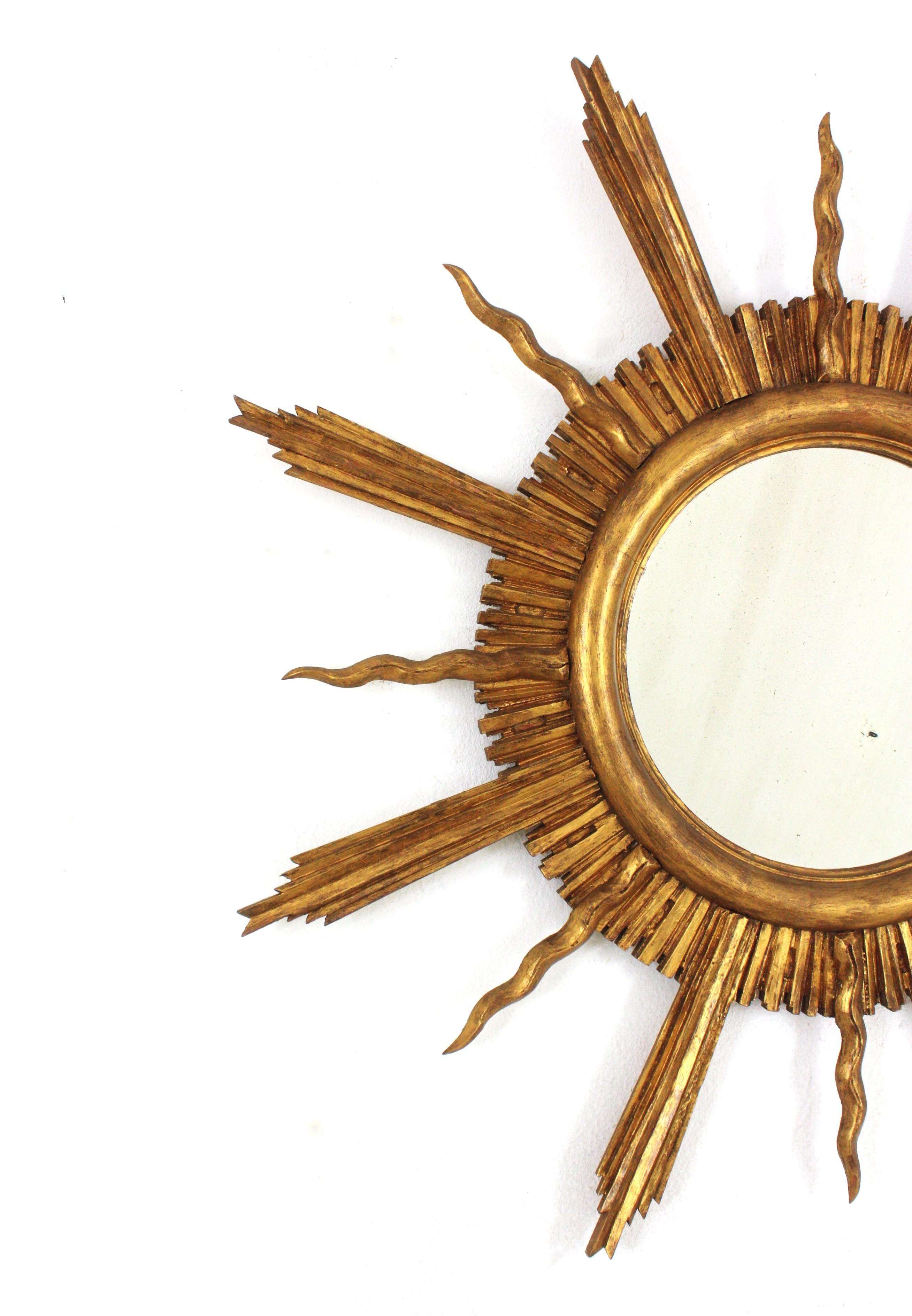 Carved Large Sunburst Starburst Giltwood Mirror in the Style of Gilbert Poillerat For Sale