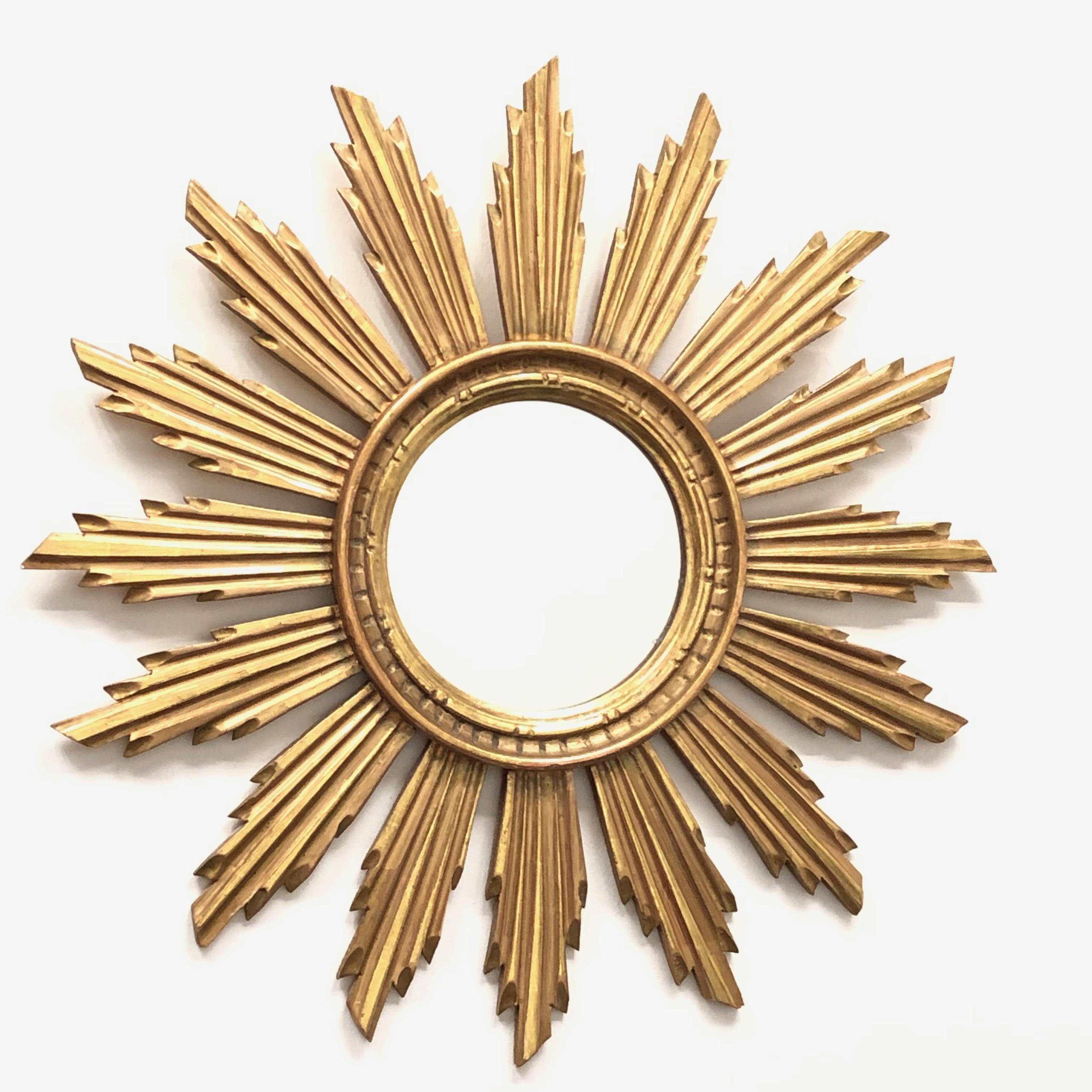 A gorgeous starburst mirror. Made of gilded wood. No chips, no cracks, no repairs. It measures approximate 22 1/4