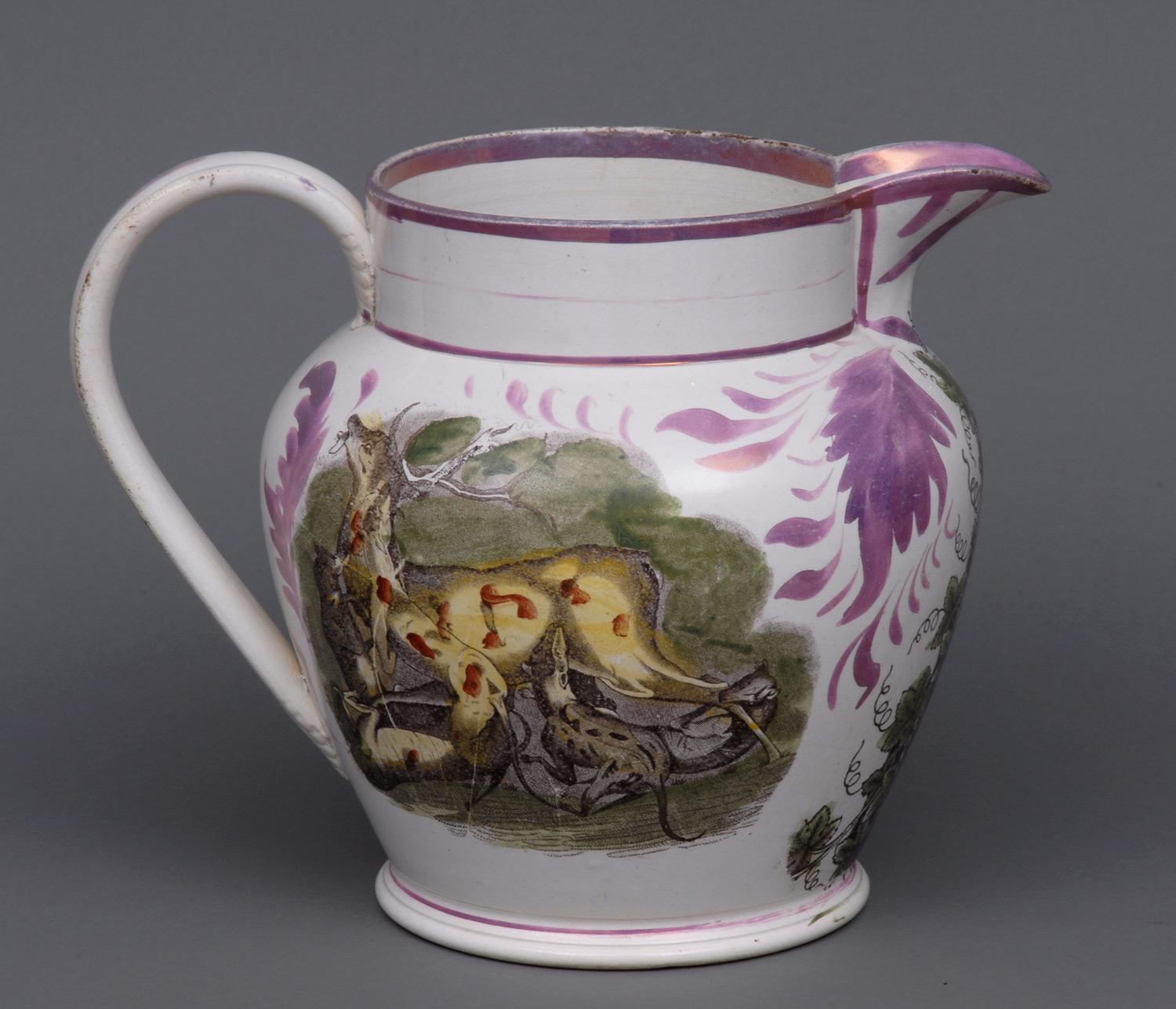 Large Sunderland pink lustre jug, decorated with hunting scenes on both sides: one side is of a figure of hunter and dog with a stag; the other side is of coyote and stag. Grapes, leaves and vines decorate the area under the spout.