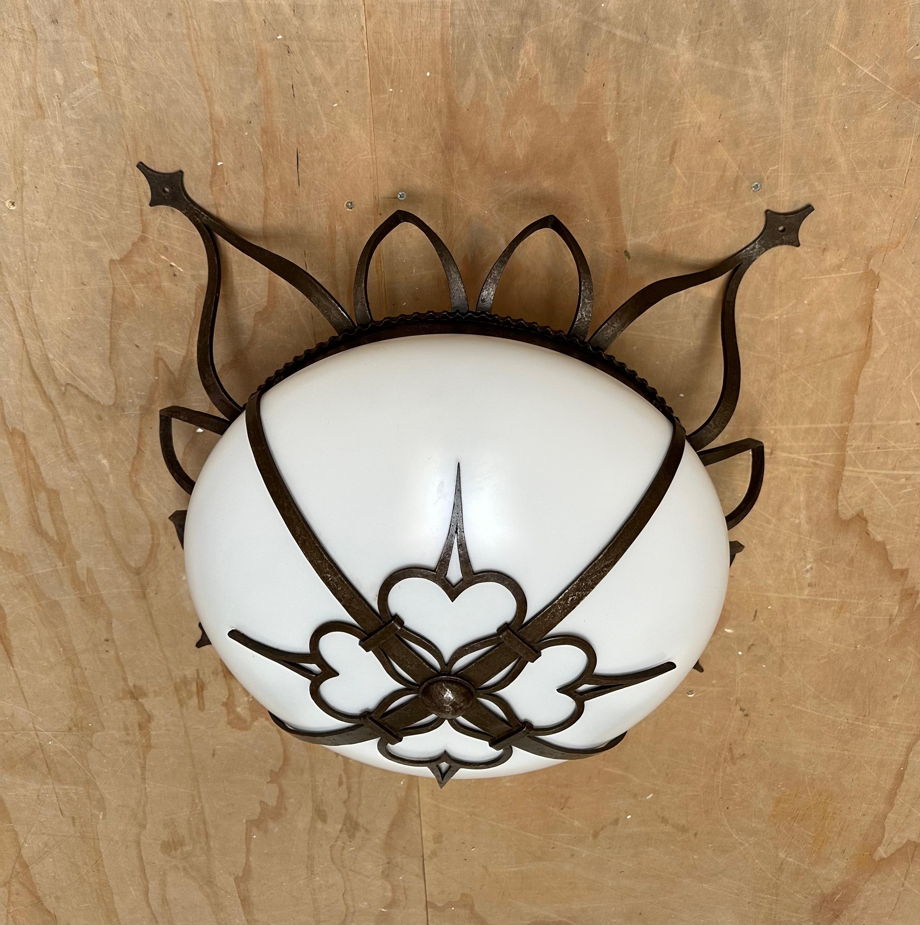 Antique hand crafted, stylized sunburst design two light flushmount / fixture.

This 1920s two-light flush mount has the most serene look and feel and you will hardly ever find a light fixture from the early 1900s era in this good of a condition.