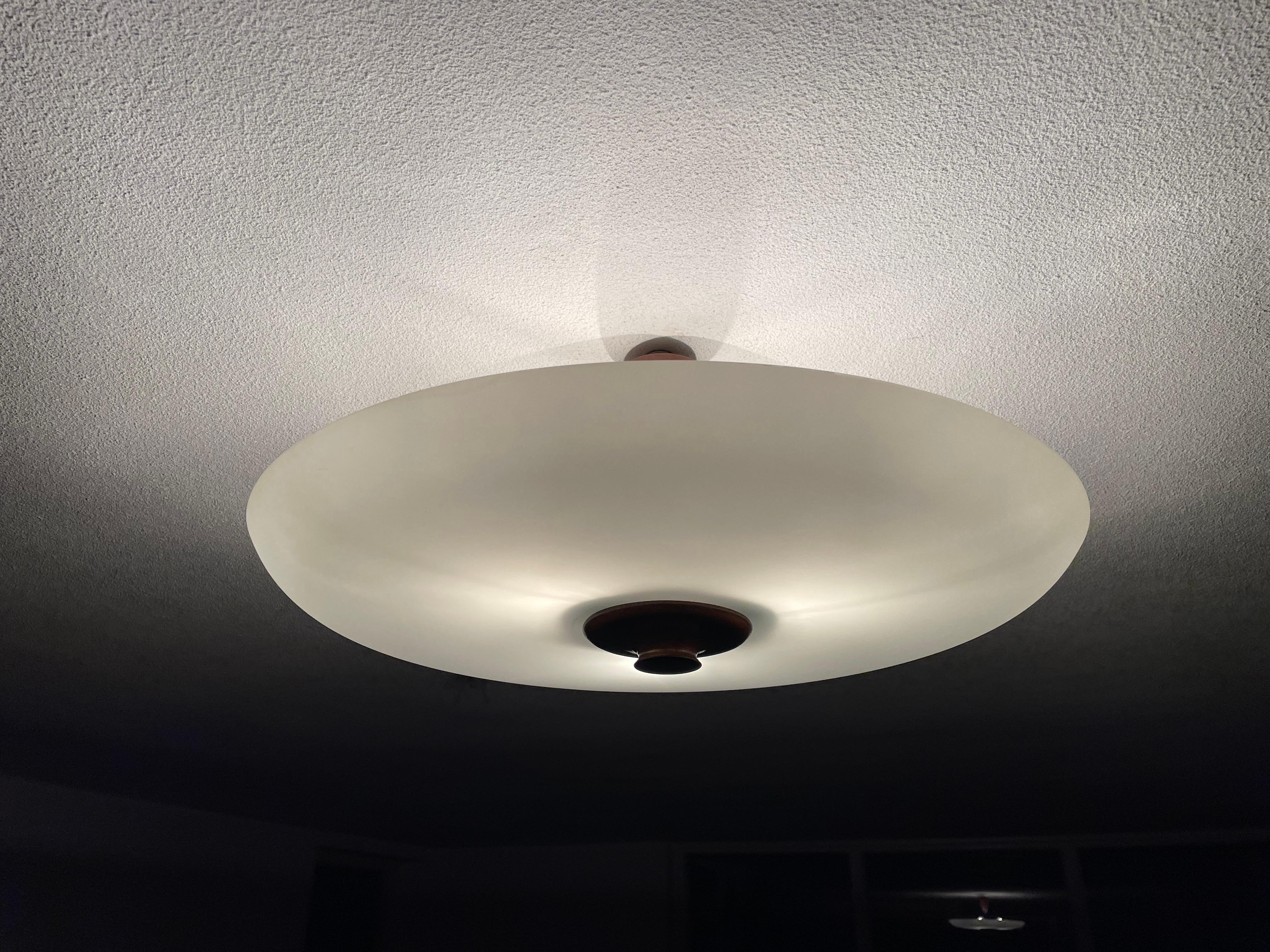 Mid-Century Modern three light flushmount.

This 1950s three-light flush mount has the most serene look and feel and you will hardly ever find a light fixture from the Mid-Century era in this good of a condition. Thanks to its matt white, single