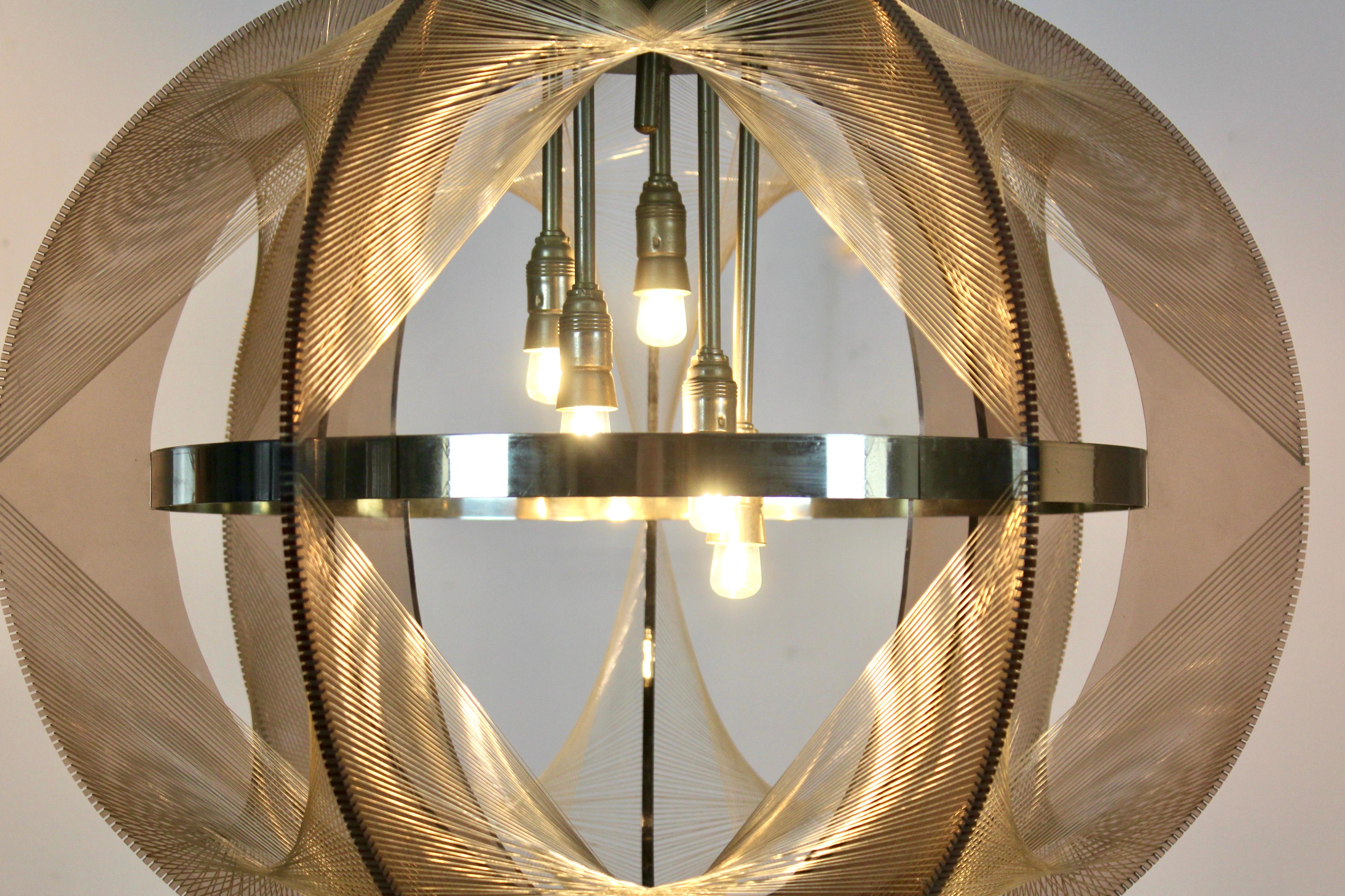 Sophisticated X-large clear wire pendant lamp designed by Paul Secon for Sompex, 1970s. This beauty is made of clear Lucite with woven nylon strings surrounding five lightbulbs. Very unique in this size. The lamp measures 55cm height, with the wire
