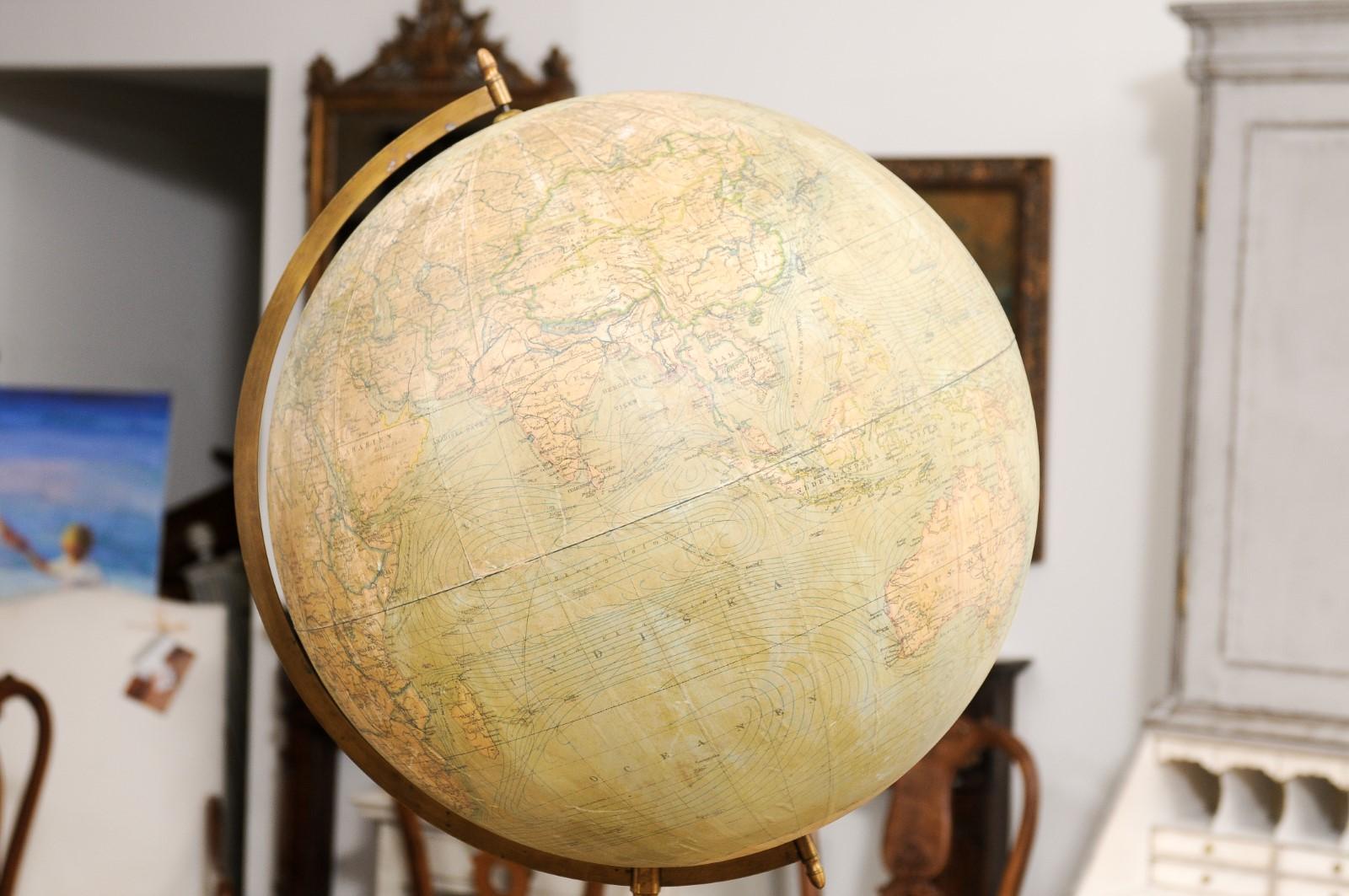 A large Swedish freestanding terrestrial globe from the early 20th century, on triangular carved base. Created in Sweden during the first decade of the 20th century, this globe attracts our attention with its large proportions and complimenting