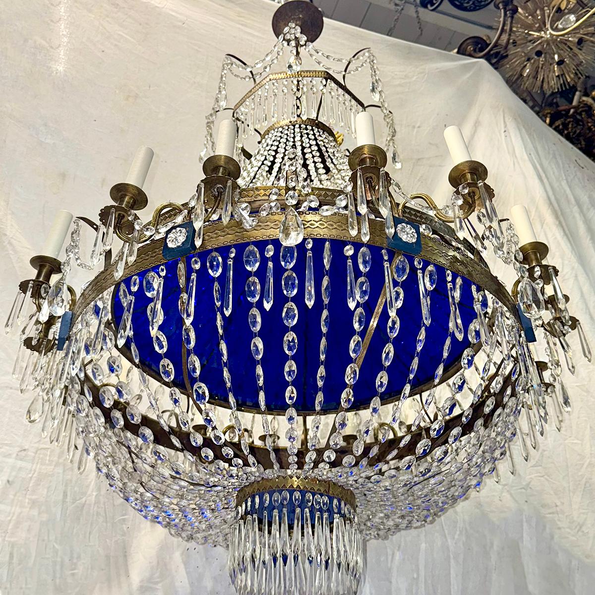 A circa 1900 Swedish chandelier with crystal pendants and blue glass inset. 16 candelabra lights

Measurements:
Min. Drop: 44