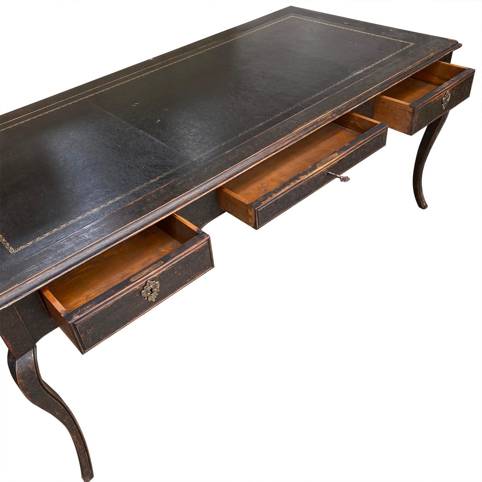 Large Swedish Gustavian black painted faux partners writing desk with three drawers

Desk has the original brass hardware and key.
Seat height is 23.75 inches.