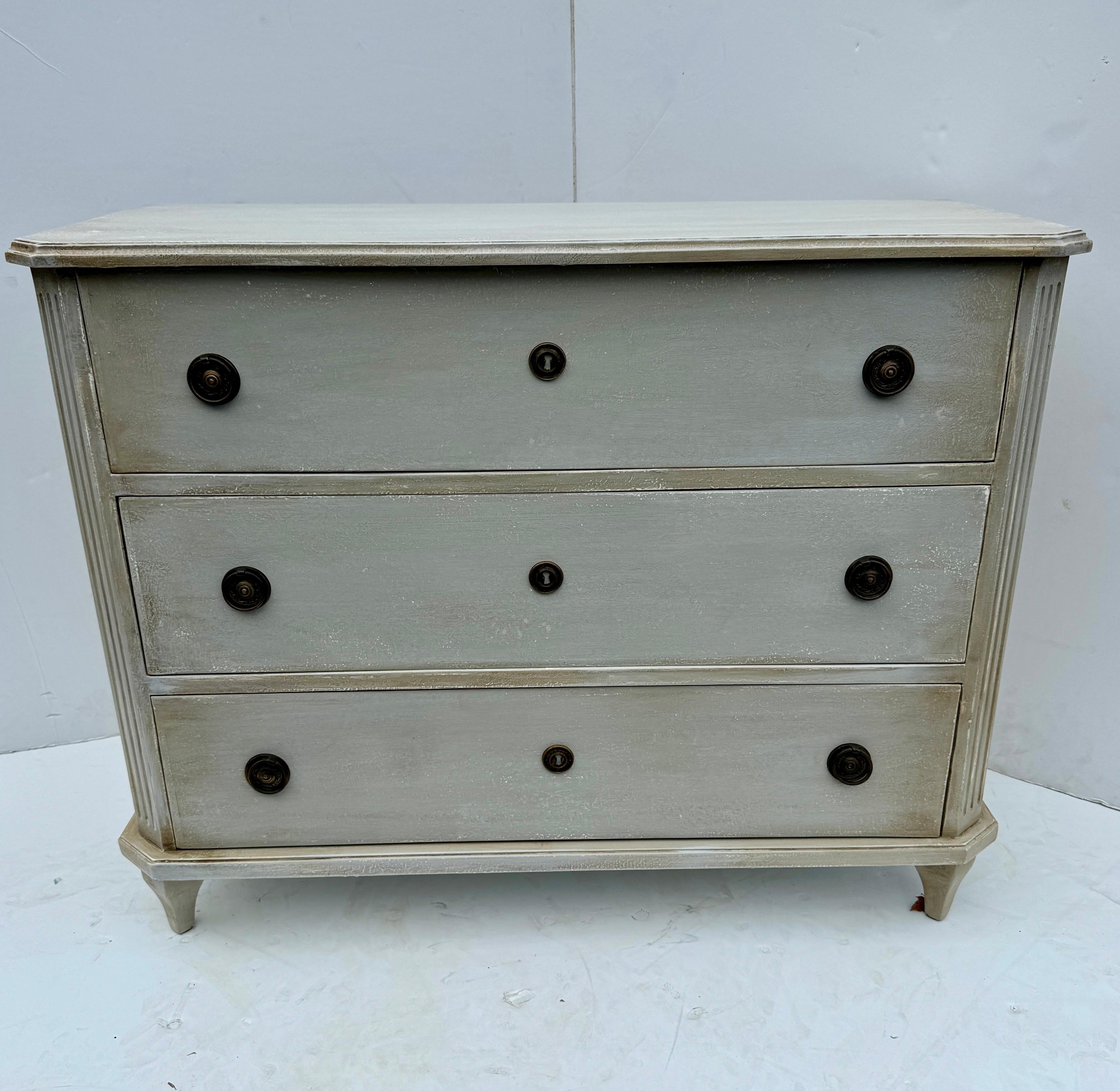 Gray Painted Swedish Gustavian Style 3 Drawer Chest Bureau. This three drawer bureau is based on an 18th Century Gustavian antique chest of drawers. The chest is handmade and hand painted with solid wood legs and frame. The detailing is impeccable