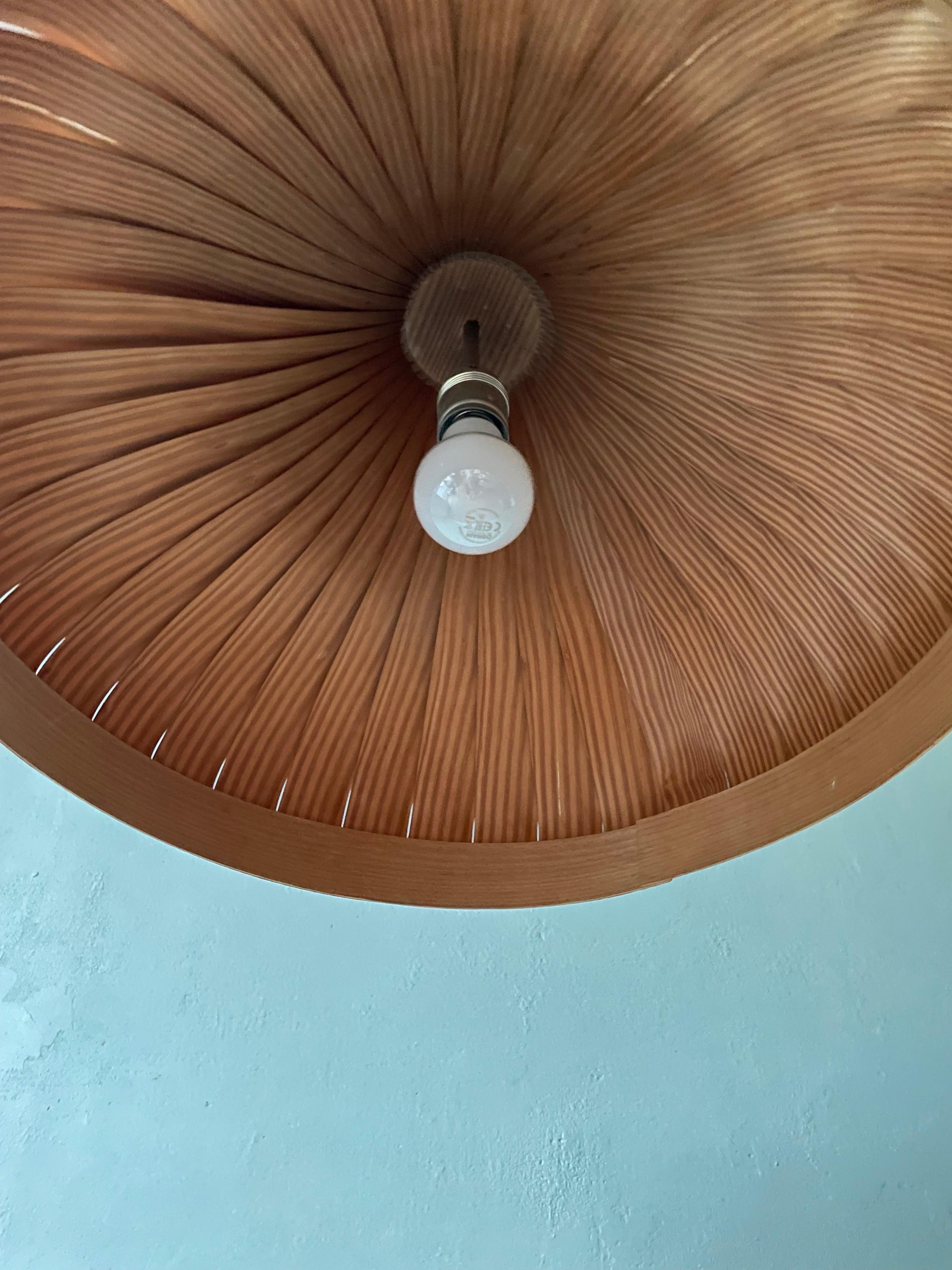 Extraordinary, rare and large Scandinavian midcentury organic modern ceiling light designed by Hans-Agne Jakobsson for Swedish Ellysett. Handmade with slender pine wood veneer slats bent into shape of a swirling slender neck and a large open base.