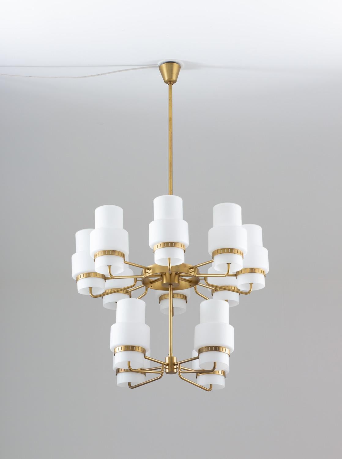 Stunning chandeliers in brass and frosted opaline glass, possibly manufactured by ASEA, Sweden, 1940s.
These majestic lamps give a soft, atmospheric light due to the opaline glass shades. 
Measure: The height of the brass stem can be altered