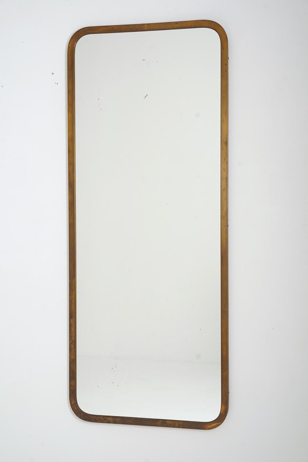 A beautiful modernist mirror produced by Nordiska Kompaniet (NK), circa 1950.
The design is simple and expresses a low key elegance, typical for the Swedish Modern design era.

Condition: Very good condition with perfect patina on the brass. Signs