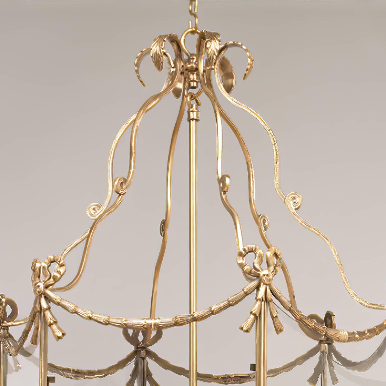 The large Swedish neoclassic style five-light brass hall lantern with 18th century style embellishments. The leaf tip crown above scrolling supports and a hexagonal frame decorated with bowknots, tassels, and bellflower swags. The base decorated