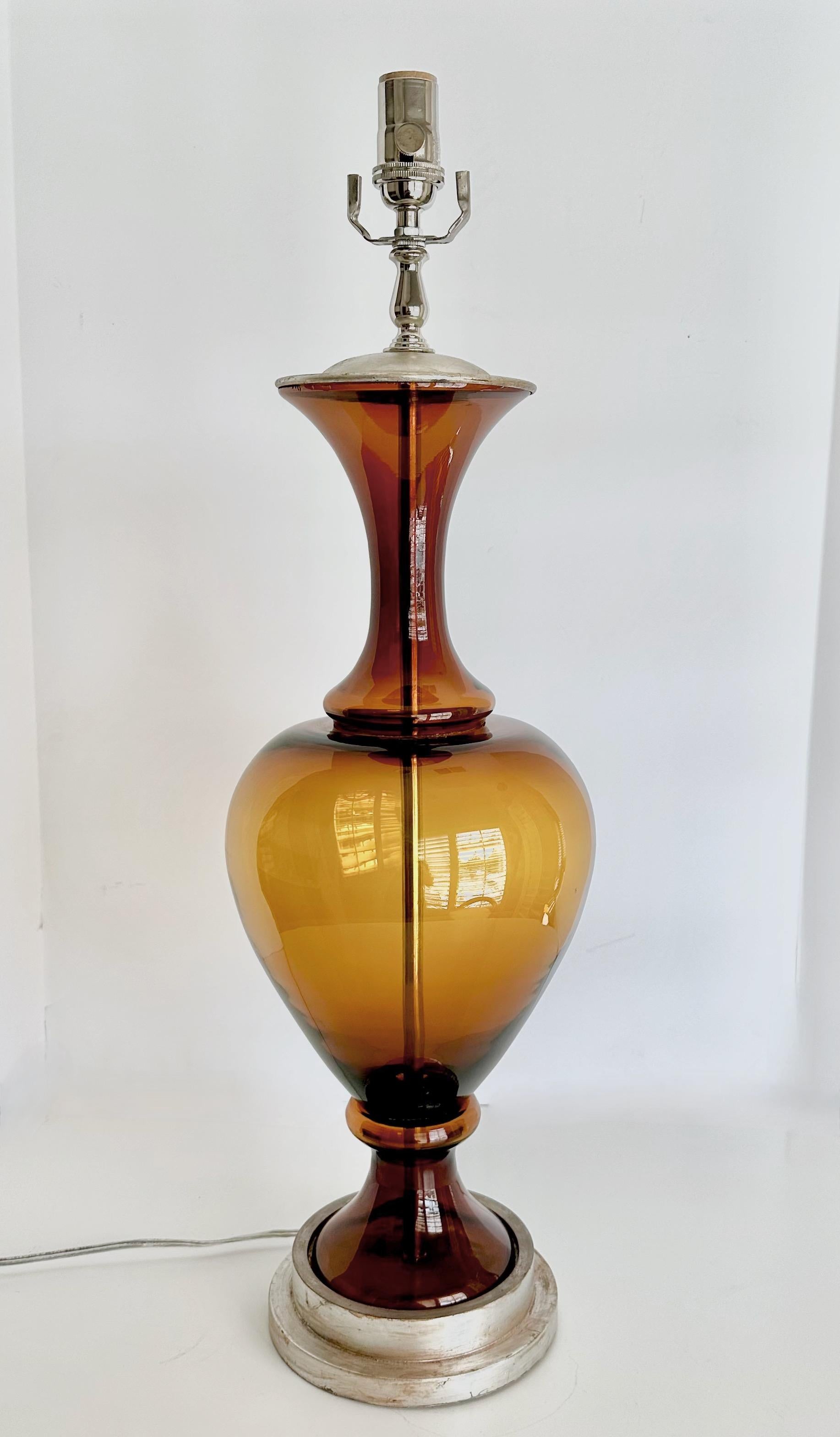 Large Swedish table lamp with root beer colored blown glass body mounted silver giltwood base. Newly wired for US with new 3 way socket and cord.
Size to top of glass portion is 21