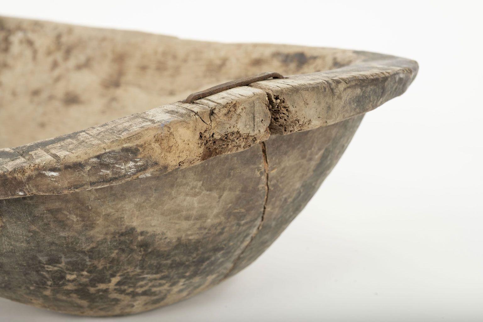 Large Swedish rustic trencher bowl, hand-carved in beech. Old iron staple repairs. Dates to 19th century.