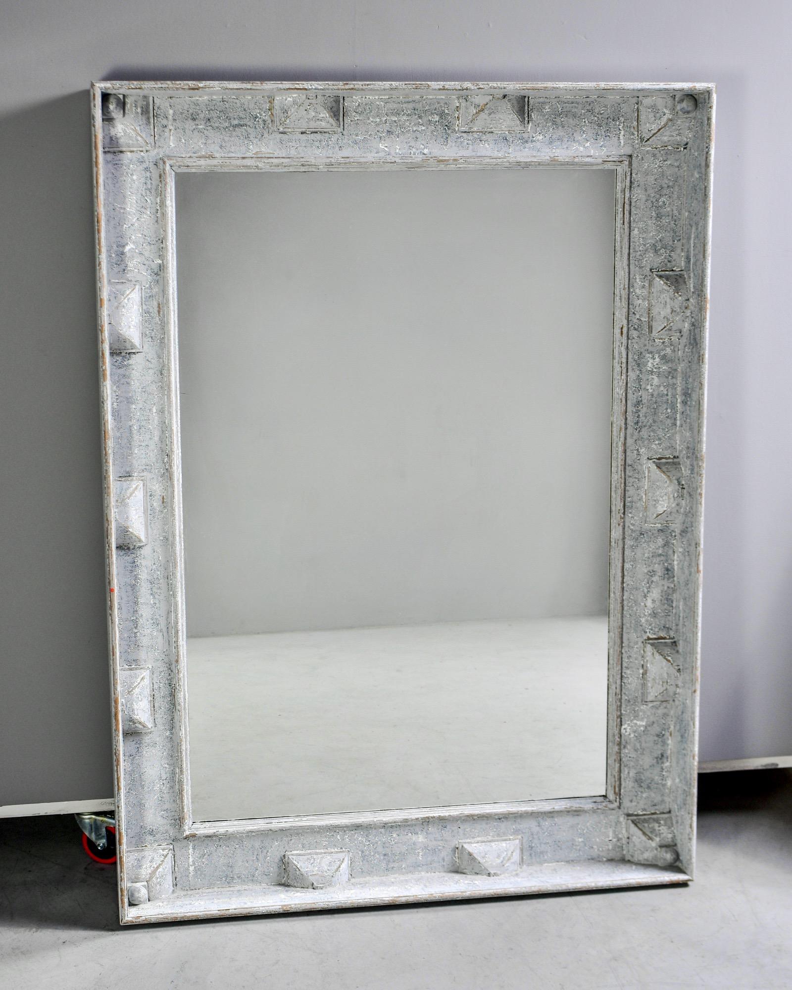 Large Swedish style mirror measures over five feet tall, circa 2010. Wide wooden frame has a decorative border of raised, pyramid-like forms and a gray-blue painted finish. Actual mirror is 51.75” high x 35” wide. Unknown maker.
 