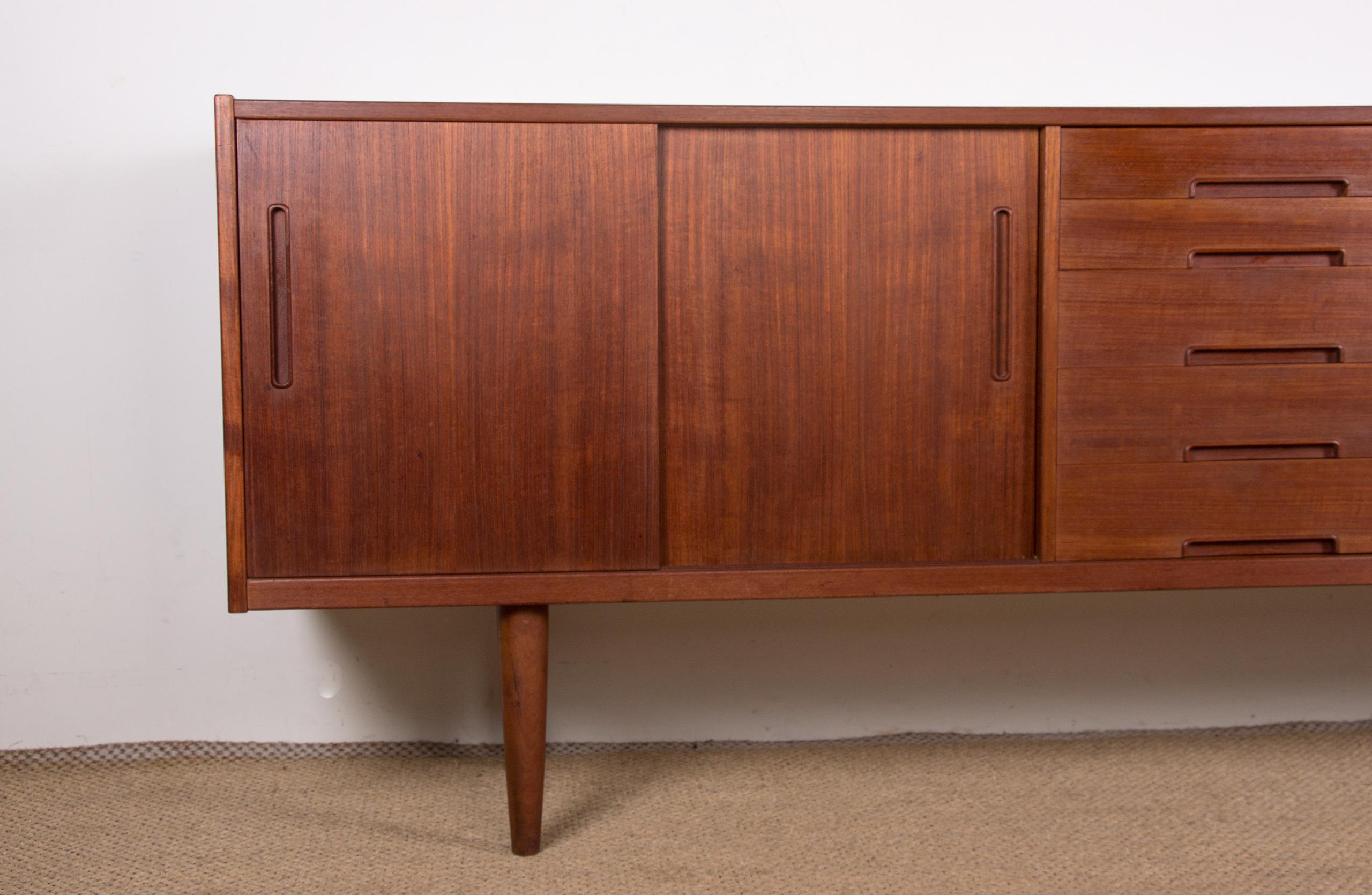 Superb Scandinavian sideboard. 2 times 2 doors on the sides open onto 2 large shelves, 5 drawers of different sizes in the middle. Furniture with a very elegant modernist design, very good manufacturing quality, large storage capacity.