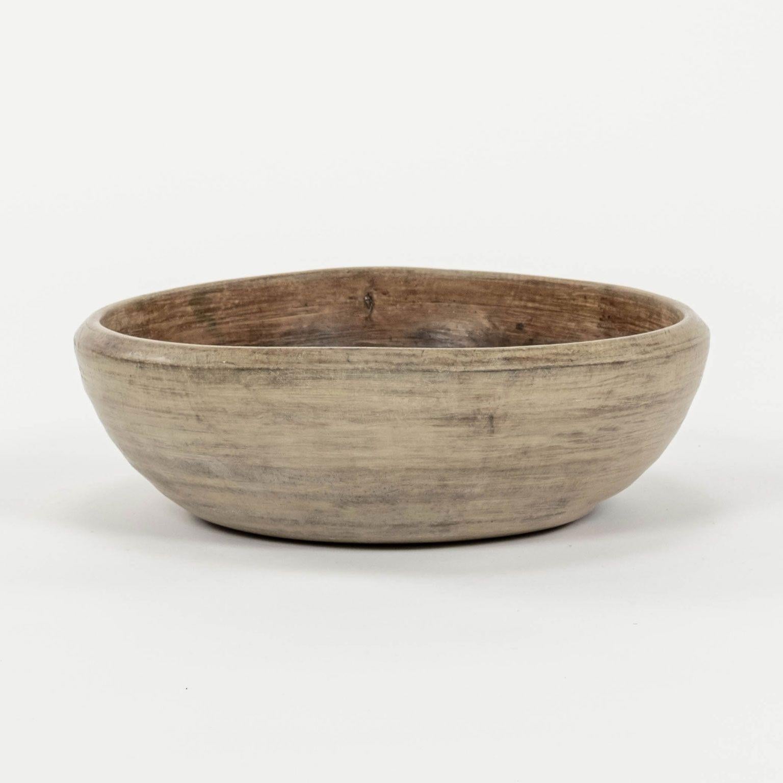 Large Swedish turned walnut dough bowl. Semi-bleached and scrubbed light brown color. Good heavy weight and size.

Note: Due to regional changes in humidity and climate during shipping, antique wood may shrink and/or split along its grain, veneer