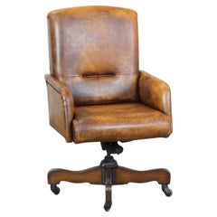 Large swivel, height-adjustable, and tiltable sheepskin office chair on wheels