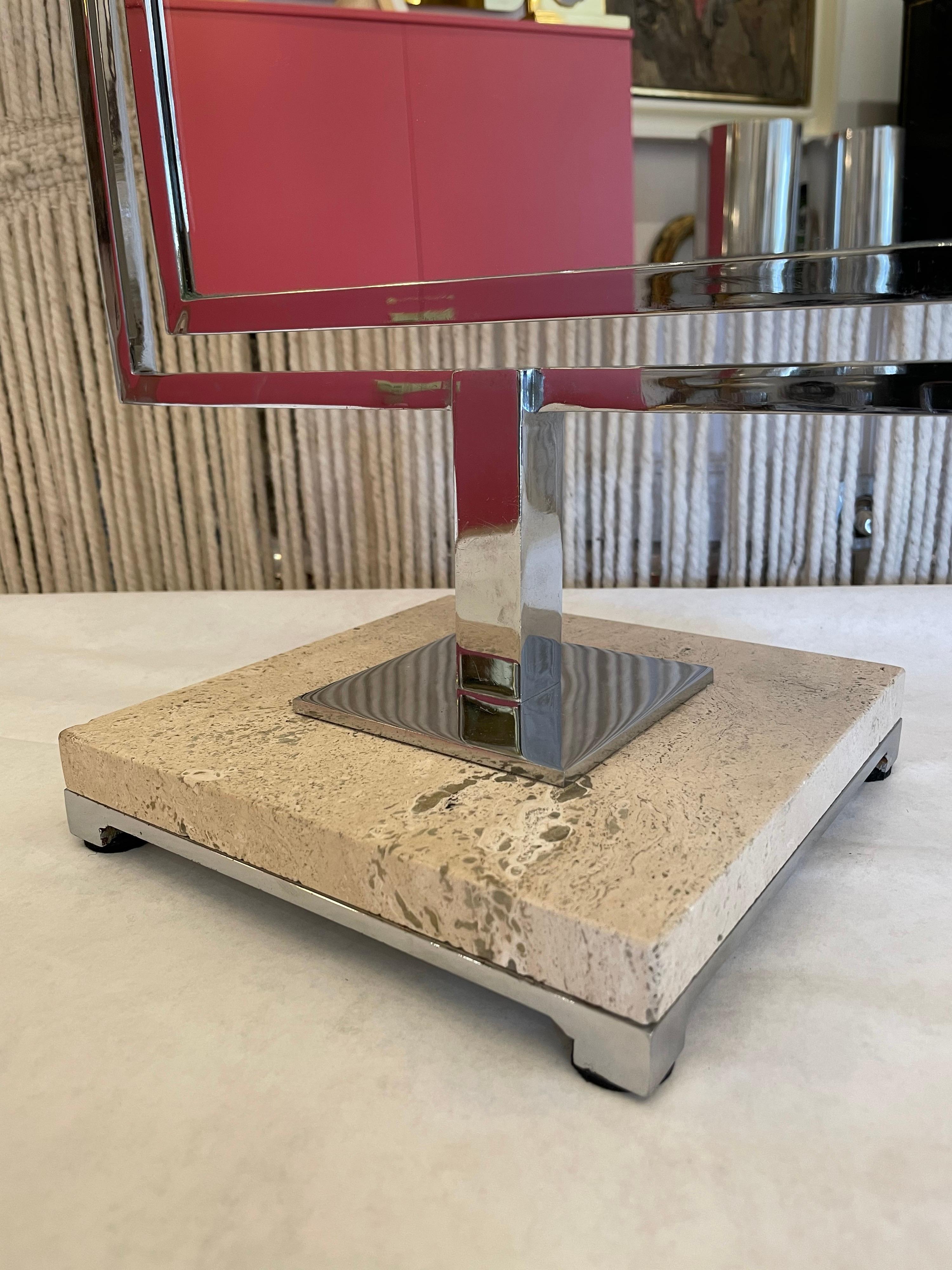 This is a two-sided vanity table top mirror with travertine and chrome base. It swivels easily and is very heavy for extra stability.
