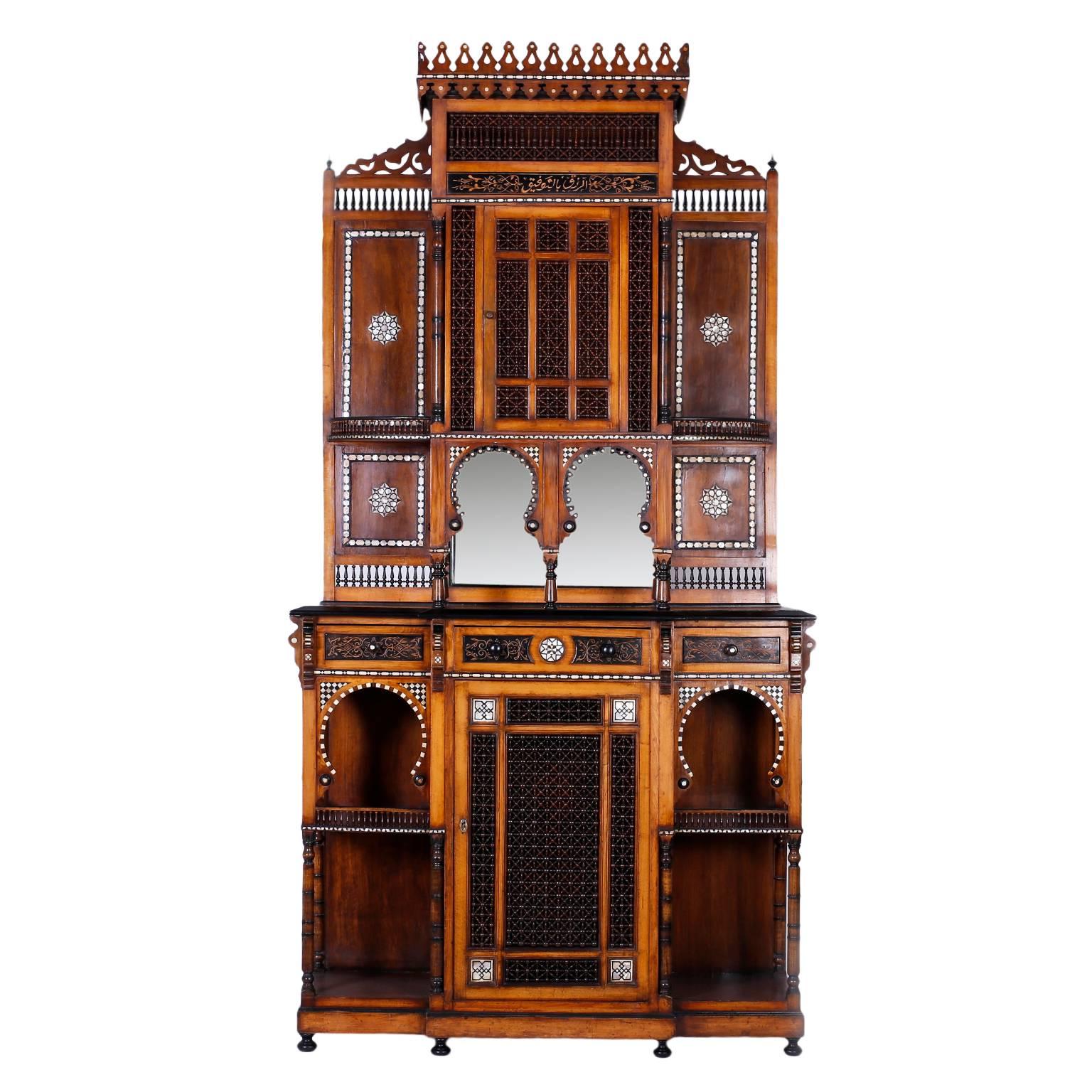 Large and impressive antique walnut Syrian cabinet, server or bar commanding architectural form. Featuring a turret gallery at the top, ebony highlights throughout, stick and ball panels, mirrored backplate, mother-of-pearl and bone inlays with