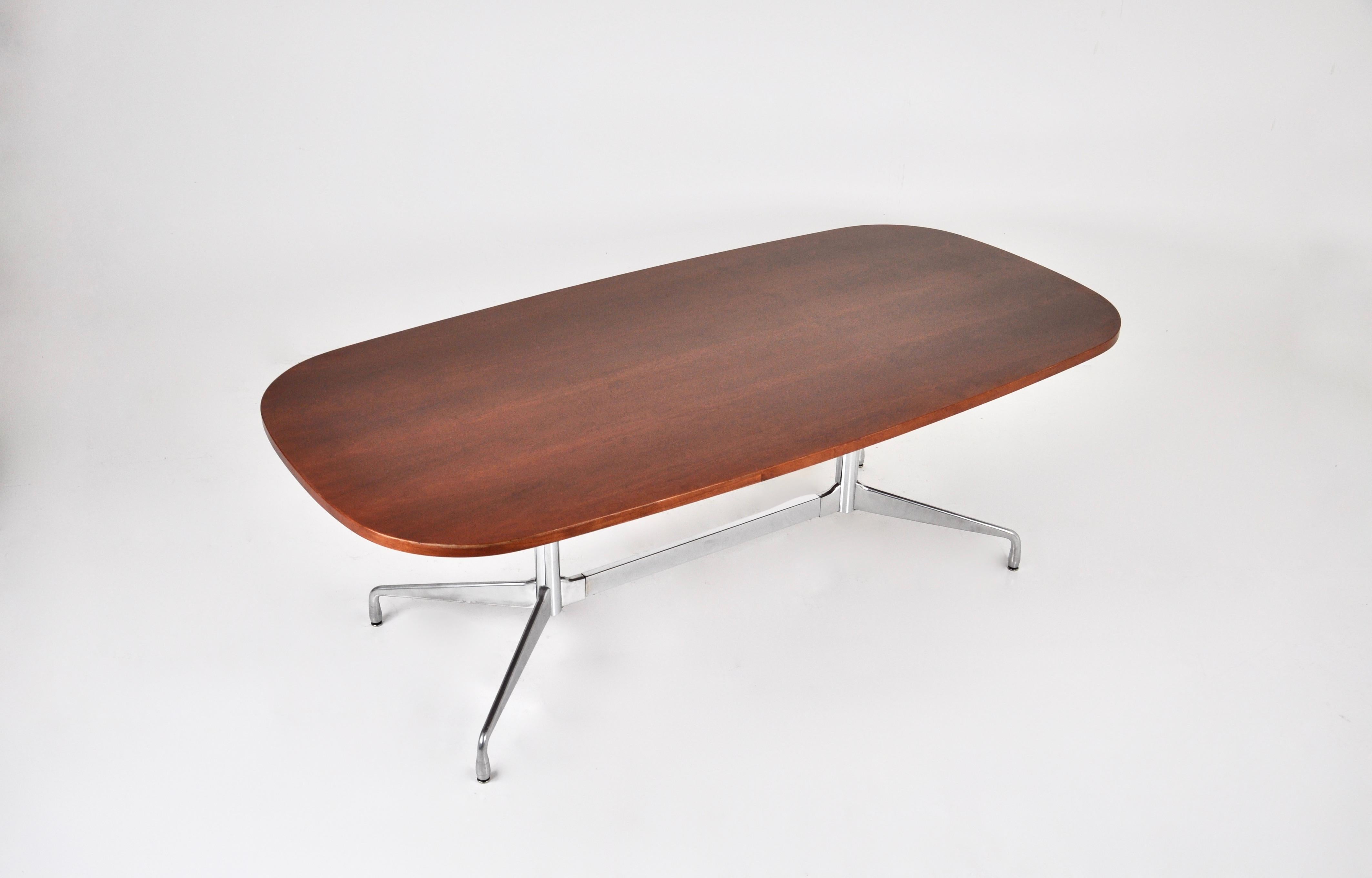 Wooden table with metal leg by Charles & Ray Eames. Wear due to time and age of the table.