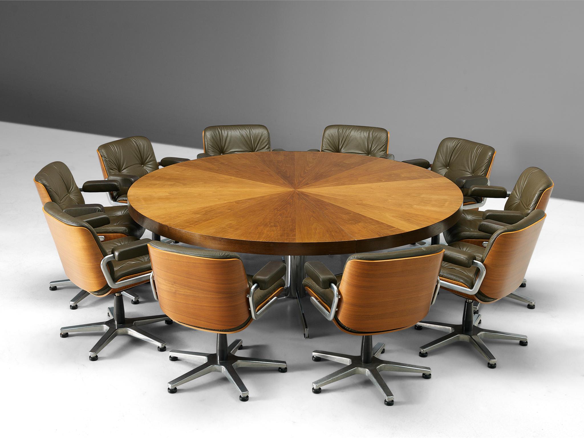 Conference table and ten swivel chairs, Italian design, walnut and metal, 1970s. 

A large round conference table accompanied by a set of ten swivel chairs. The table as well as the chairs are executed in walnut. The tabletop shows a beautiful