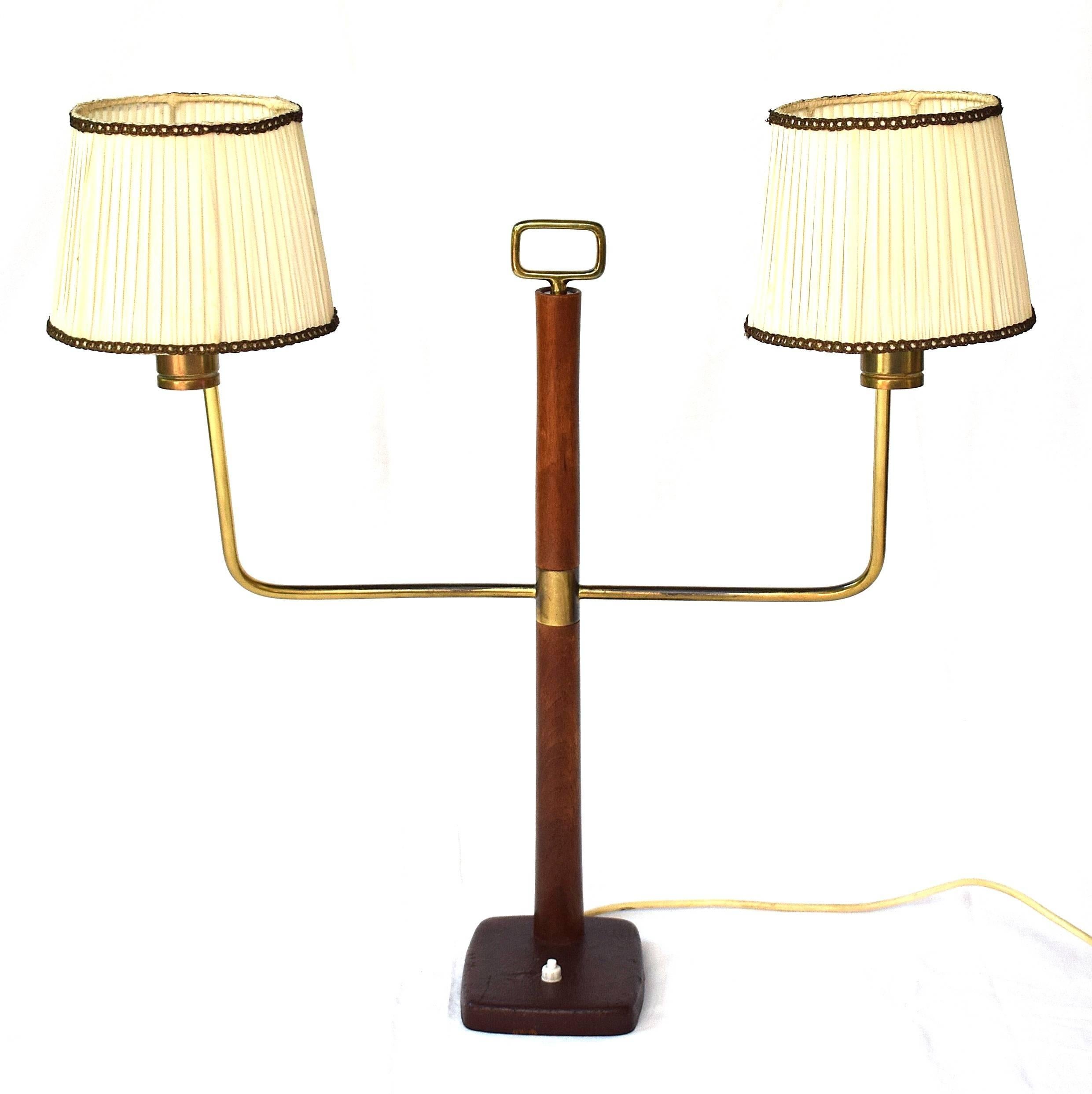 Execution J. T. Kalmar, Vienna, circa 1935, for Haus & Garten, Vienna. Brass and fruitwood, Stand covered with leather, two brass arms, two original silk fabric lampshades.

A very rare and typical product of the Austrian Werkbund: high-quality