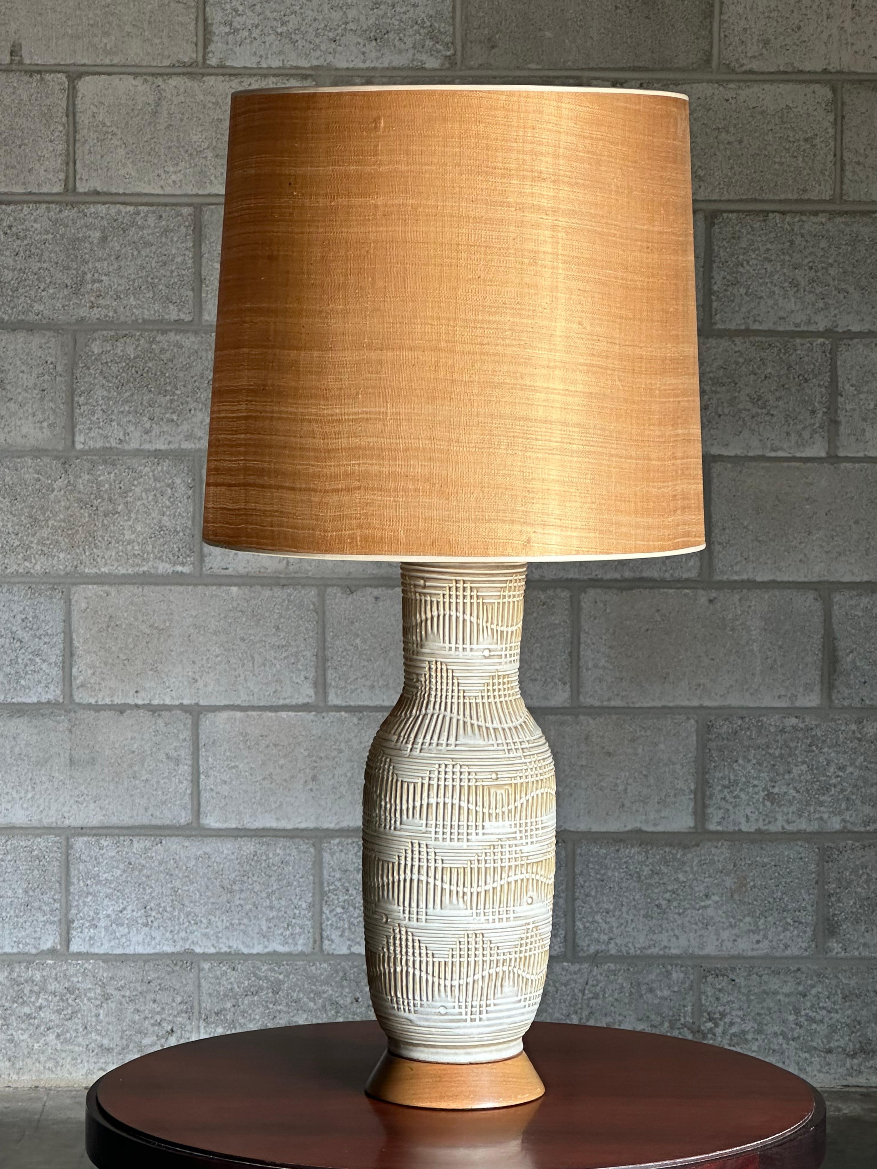 A very large and impressive table lamp designed by Lee Rosen for Design Technics. Featuires a wonderful off white and tan natural color palette with beautiful incised details. Lamp is mounted on a base and appears original, but could also be used