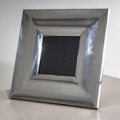 Large tabletop picture frame with a back stand and a wide metal border featuring