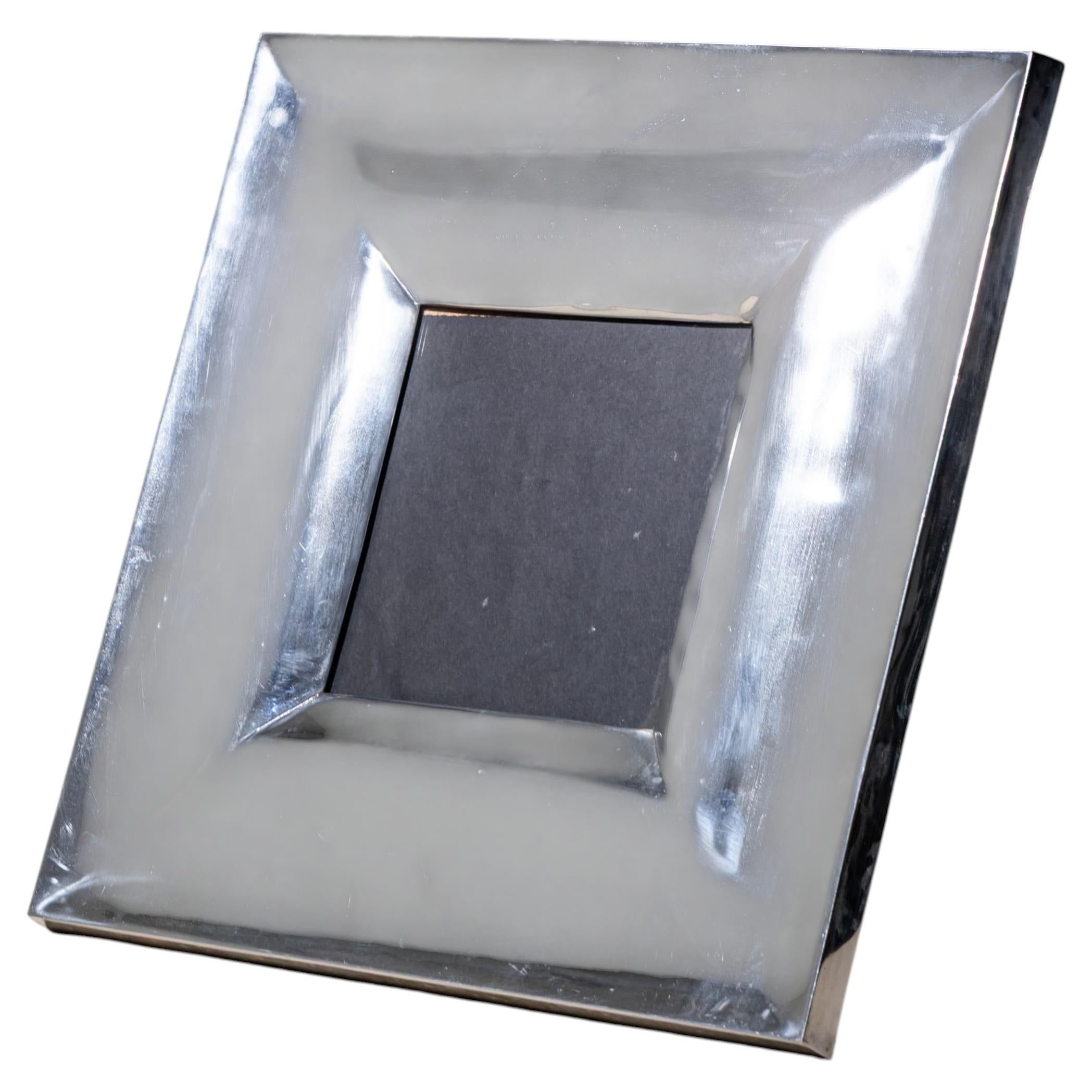 Large tabletop picture frame with a back stand and a wide metal border featuring