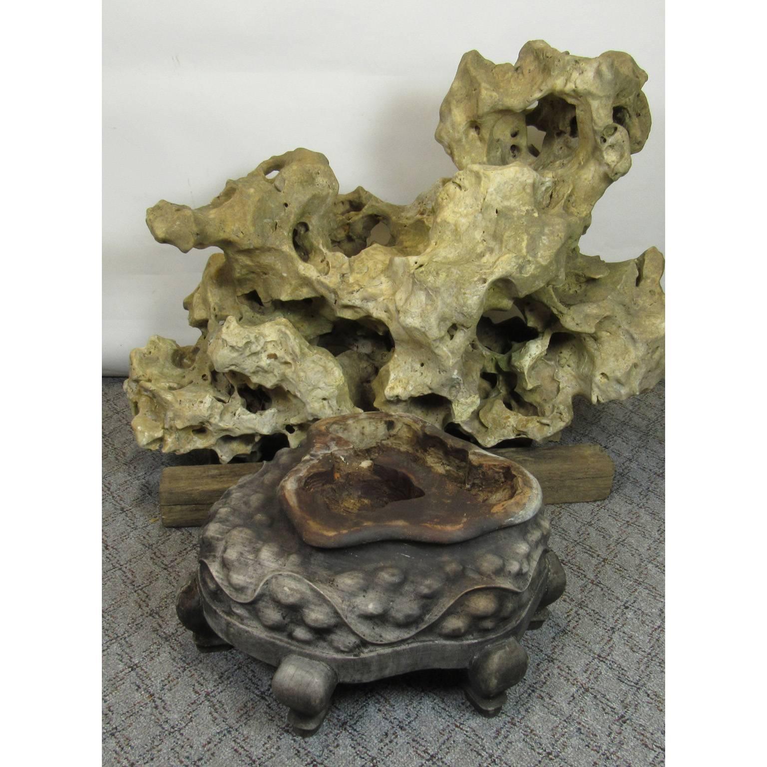 Large Taihu Gongshi (Scholar Stone) with original early 19th century hardwood carved base. Age deterioration no longer allows stone to fit into base. Could be remounted.
Dimensions: 26 x 32 x 18 inches.