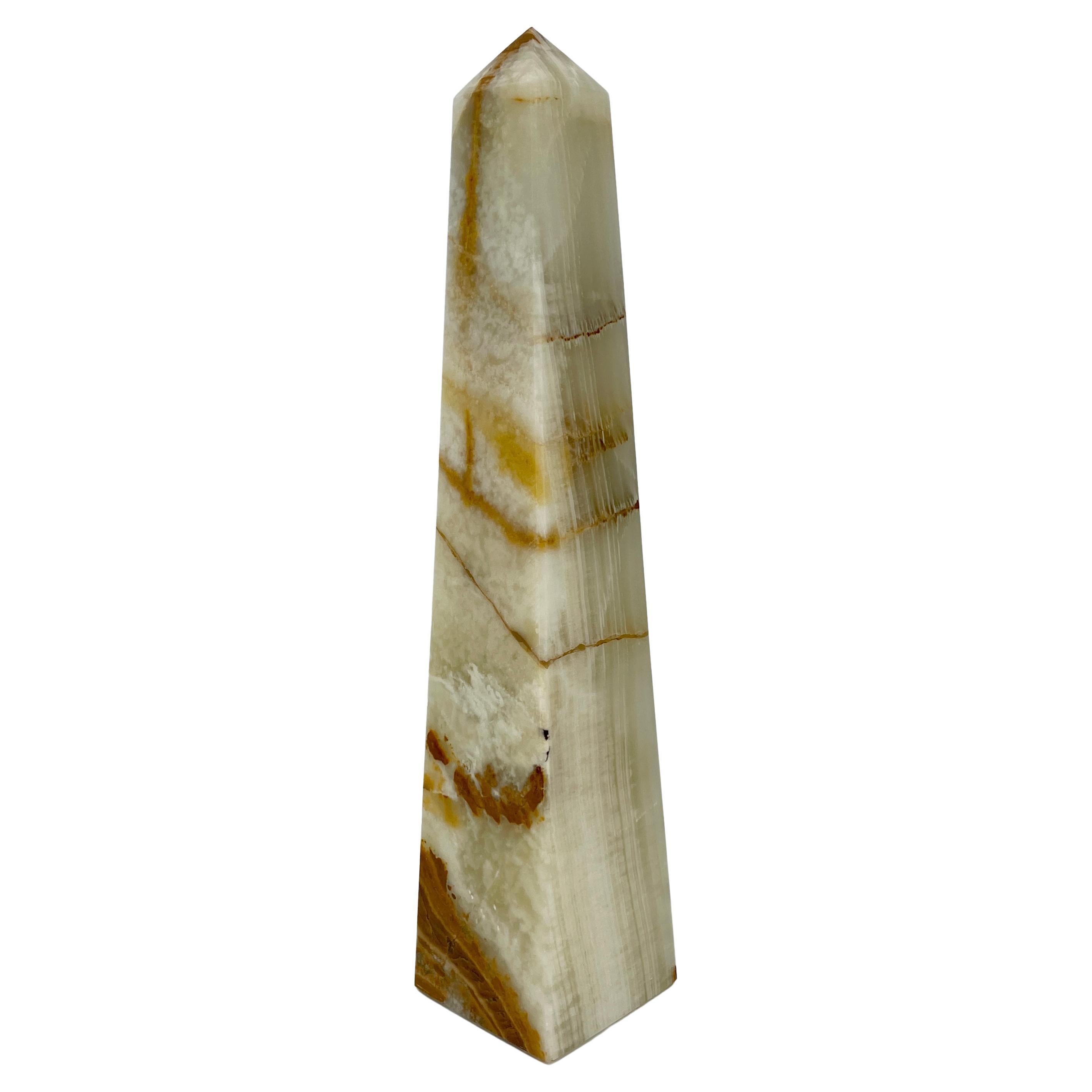 Modern green onyx obelisk, circa 1970's. This tall green or pistachio onyx obelisk is quite striking with deep burgundy veining throughout. The hand carved onyx sculpture is a modern accessory perfect for desk top, book shelf or anywhere in the home