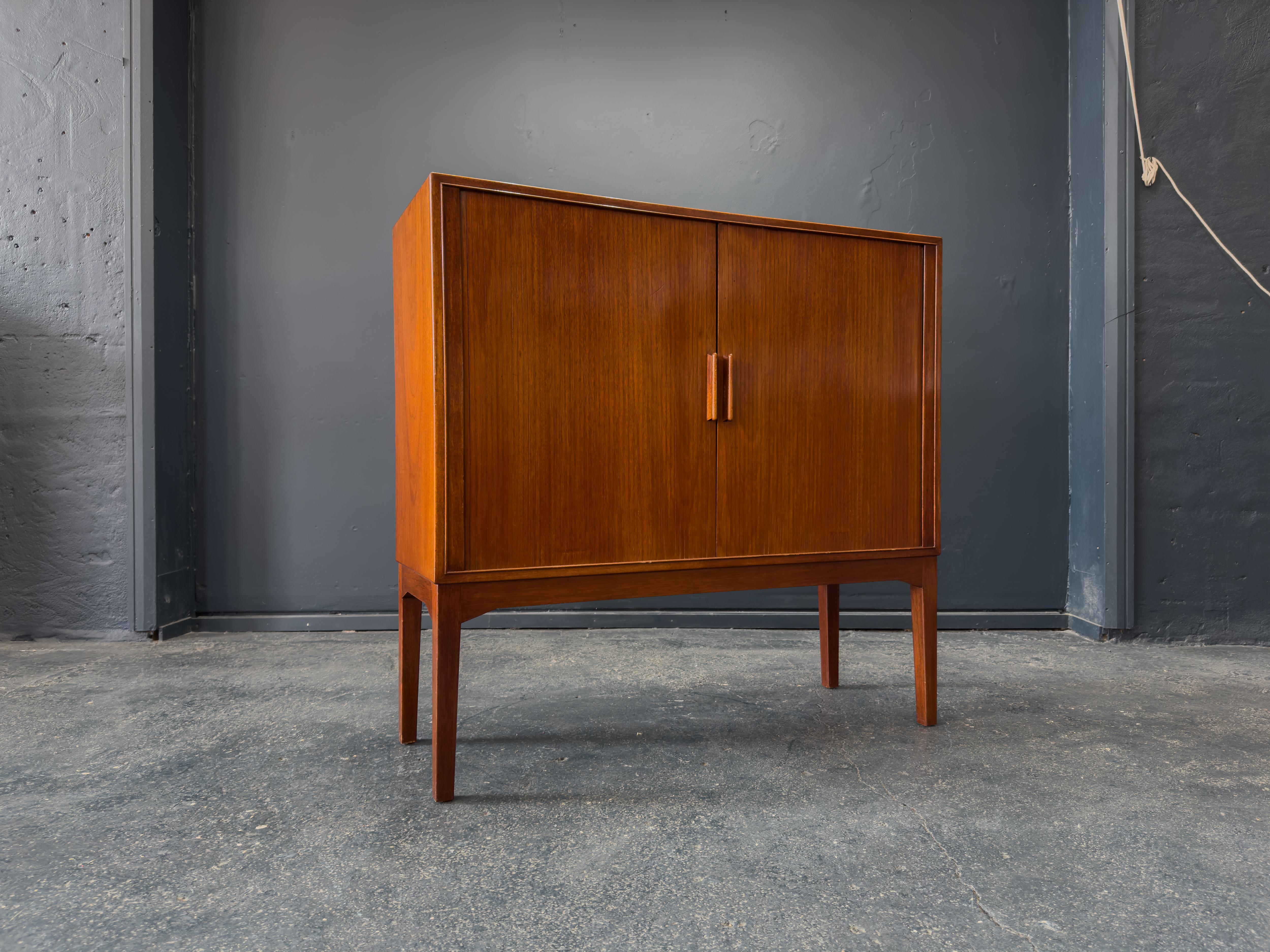 Dieser beeindruckende Schrank aus Teakholz ist ein eindrucksvolles Beispiel für dänisches Design aus der Mitte des Jahrhunderts, das sich durch seine klaren Linien, großzügigen Proportionen und außergewöhnliche Handwerkskunst auszeichnet. Das