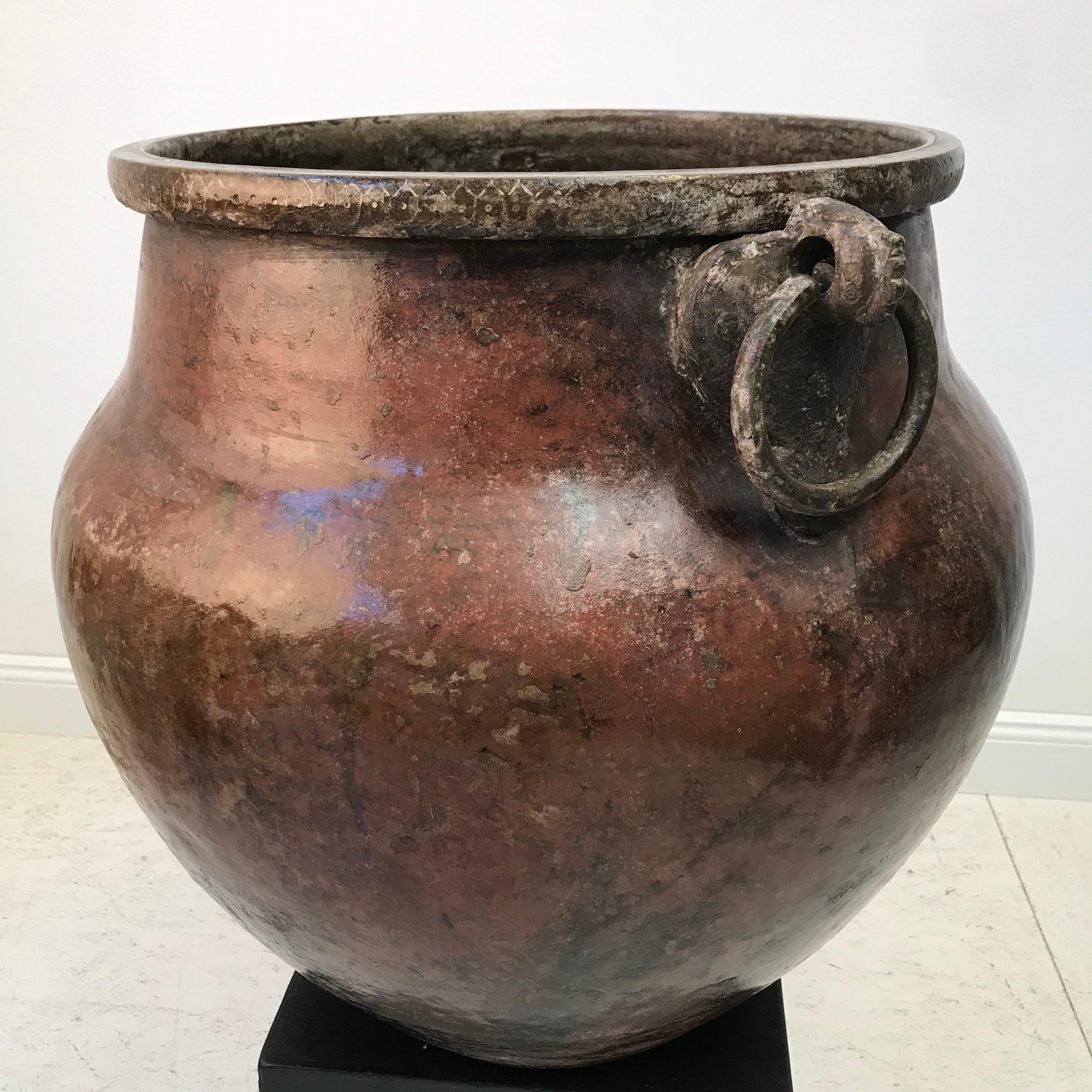 Large Tamil Nadu India brass pot. Handcrafted with a beautiful patina of brass and copper. Boastful size with presence and style. The traditional pot has good weight which is beautifully supported by 2 thick circular handles. 
A stunning piece of