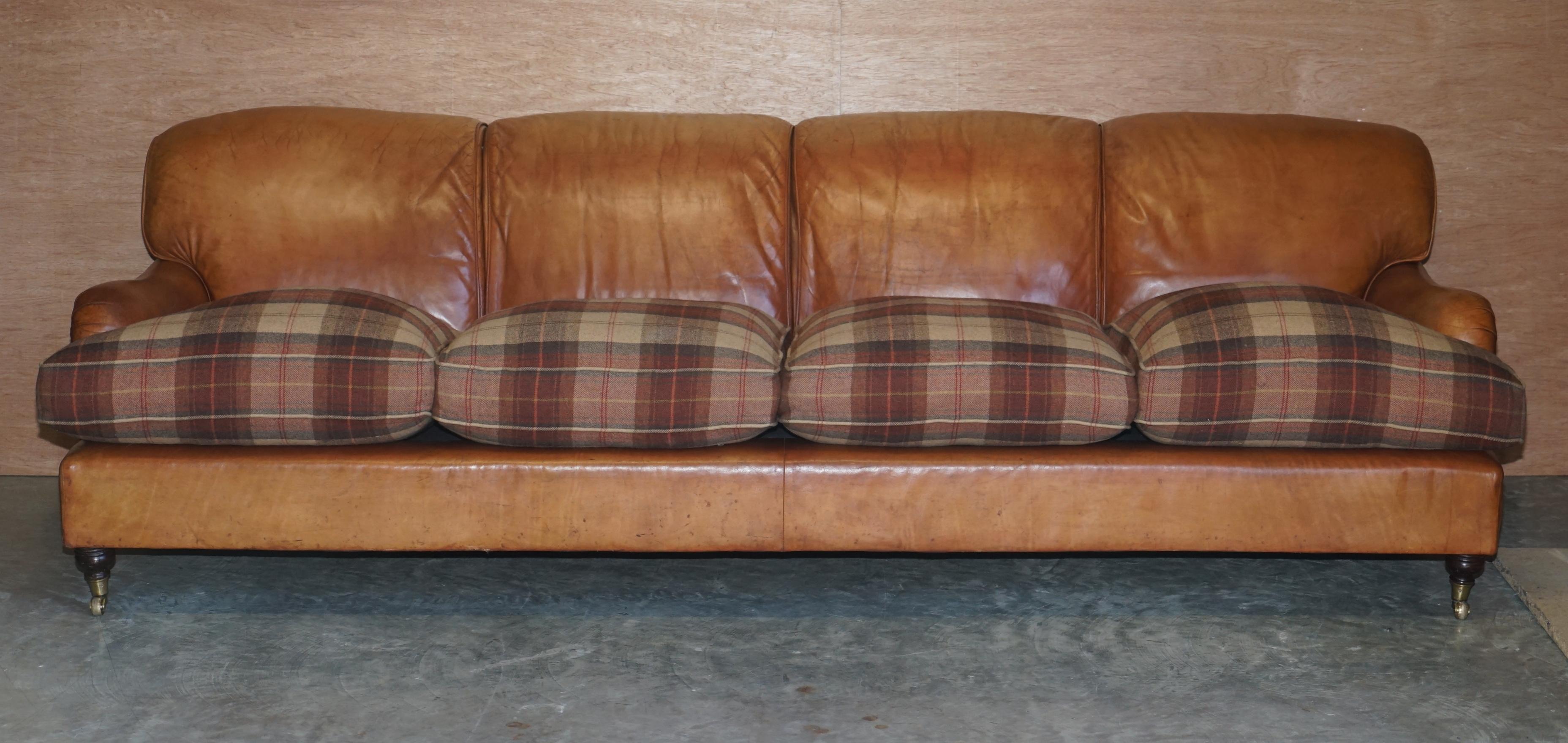 We are delighted to offer for sale this lovely handmade in England, Howard & Son’s style large four-seat hand dyed brown leather sofa with overstuffed heavy feather filled cushions upholstered with Scottish tartan wool covers

A very good looking