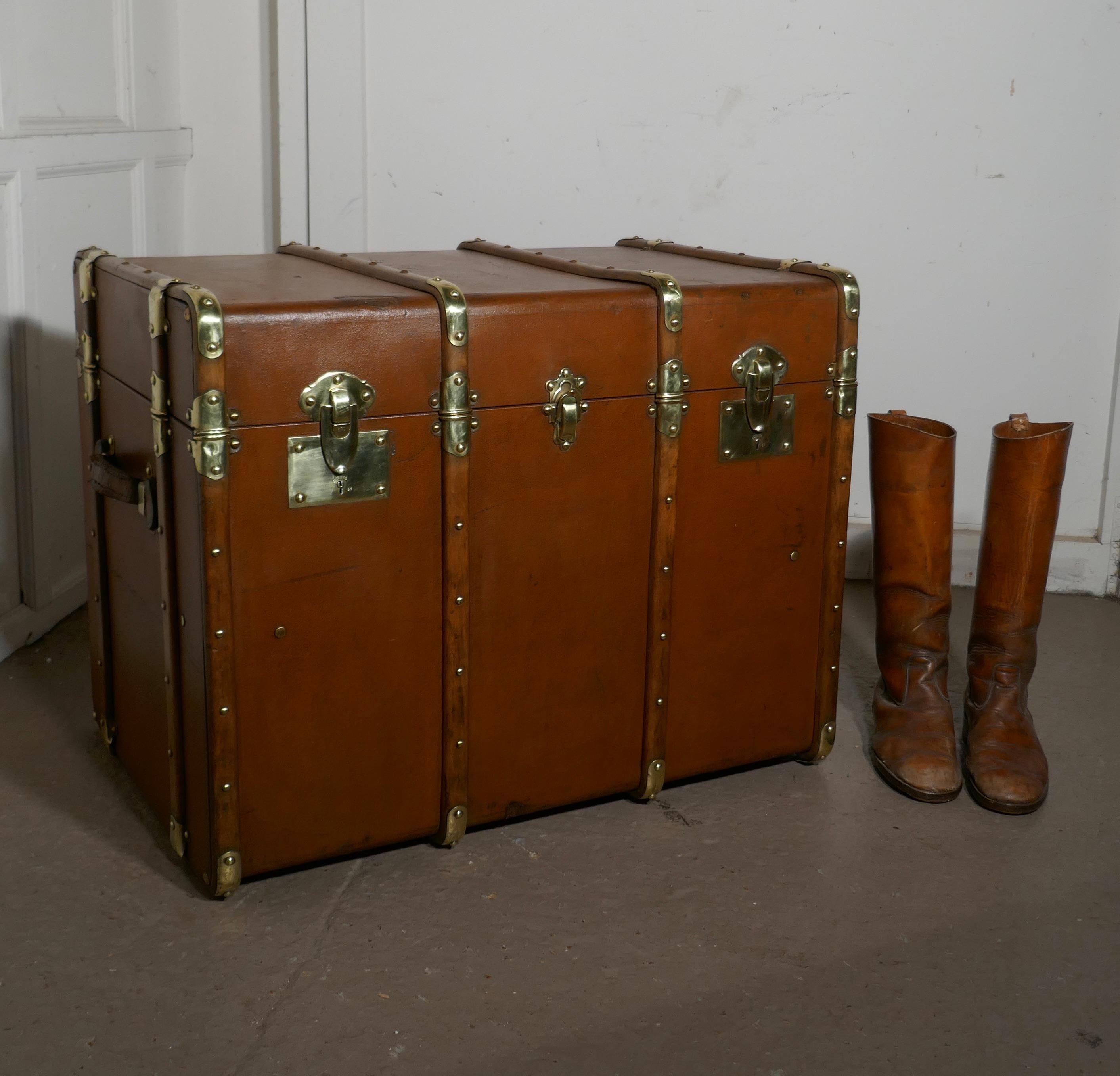 Large tan canvas, wood and brass bound steamer trunk 

This is a very top quality 19th century travel trunk, it is covered in canvas, it has wooden and brass banding and studs, on the sides there are leather carrying handles and on the front 3