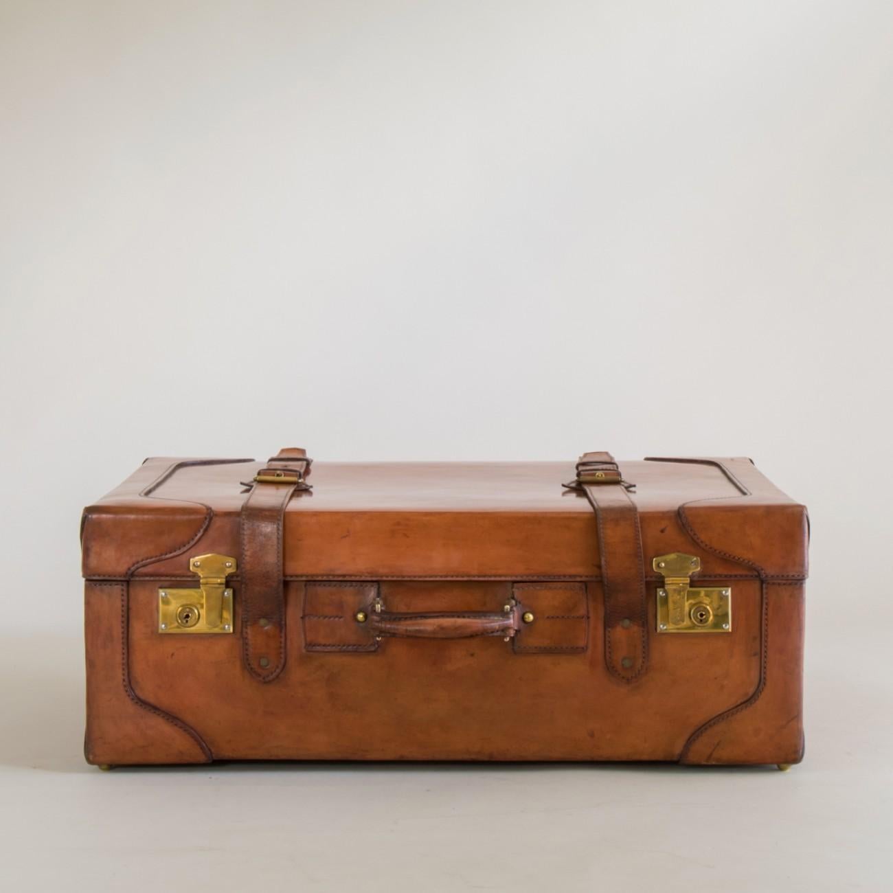 A stunning condition tan leather large suitcase with original canvas interior and tray. The case also has an original key, circa 1930.

Dimensions: 30.5cm/12 inches (height) x 76cm/30 inches (width) x 48cm/19 inches (depth)

Bentleys are Members of