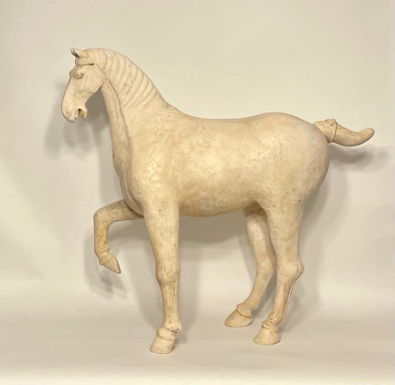 This spirited Tang Dynasty (618–907 AD) prancing horse is handsomely model with one foreleg raised, it’s mane swept to one side, expressive pricked ears, flared nostrils and open mouth bearing its teeth. The tail is docked tail and is neatly tied.