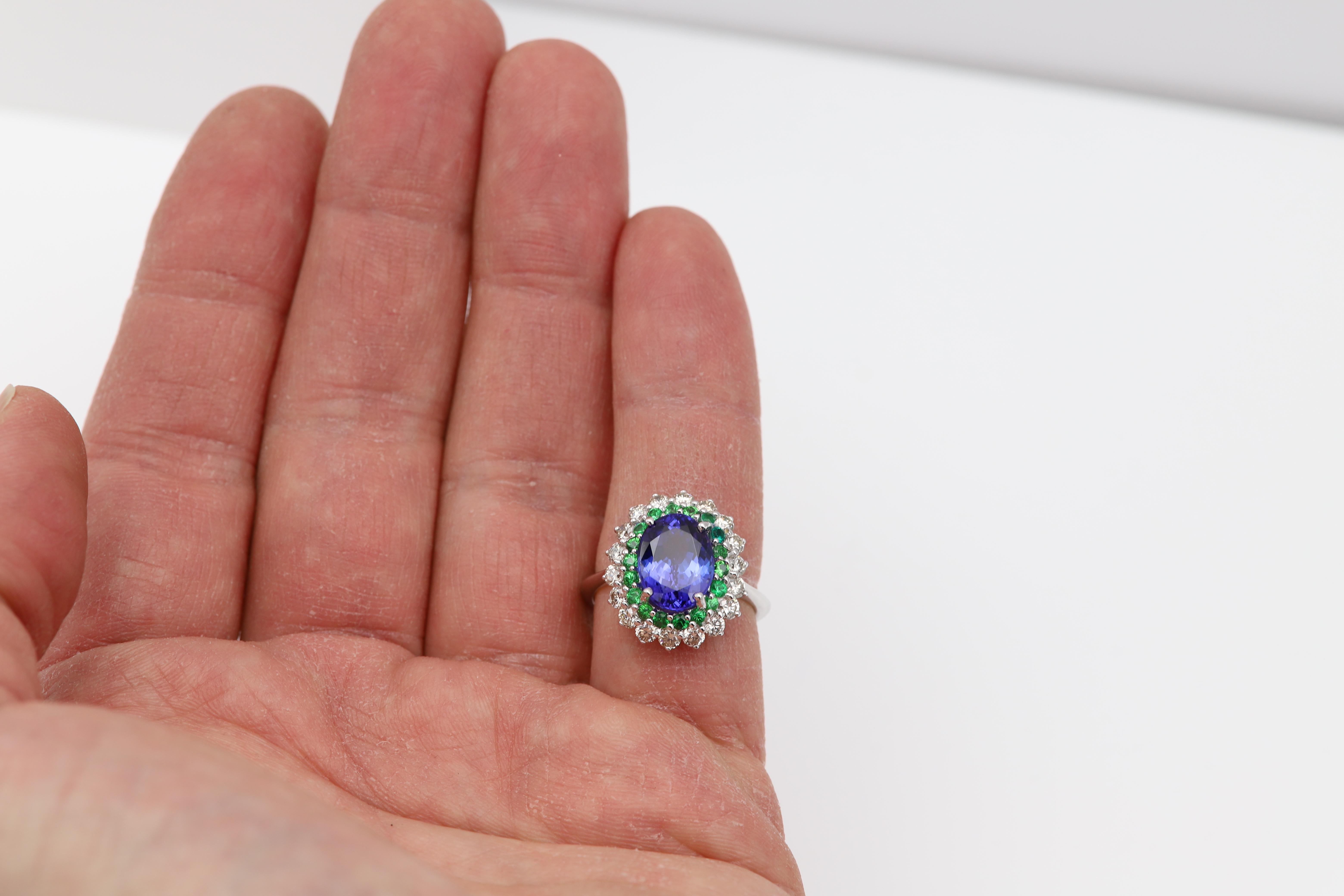 Large Oval Tanzanite Ring Diamonds and Tsavorite.
Brilliant Oval shape Tanzanite AAA Top Quality deep Blue tone 4.20 carat.
18k White Gold 6.20 grams.
Total all natural Diamonds 0.75 carat H-I-VVS.
Natural Green Tsavorite round shape 0.50 carat AAA