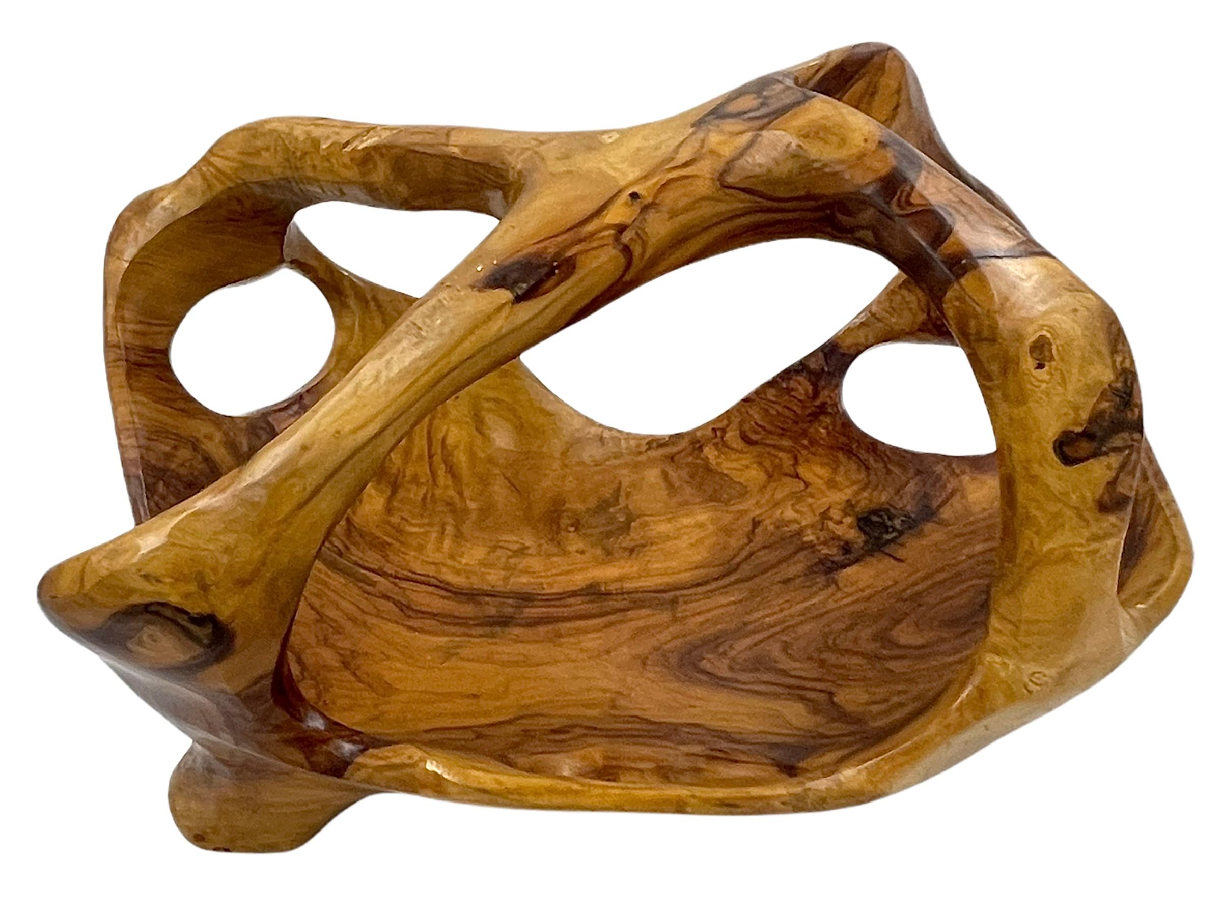 A teak burl wood bowl crafted with a shiny polished finish. The bowl was cut from a much larger slab of burl wood and maintains an incredibly organic shape that is rich in texture.

Measures: 8.75” x 15” x 11”.
