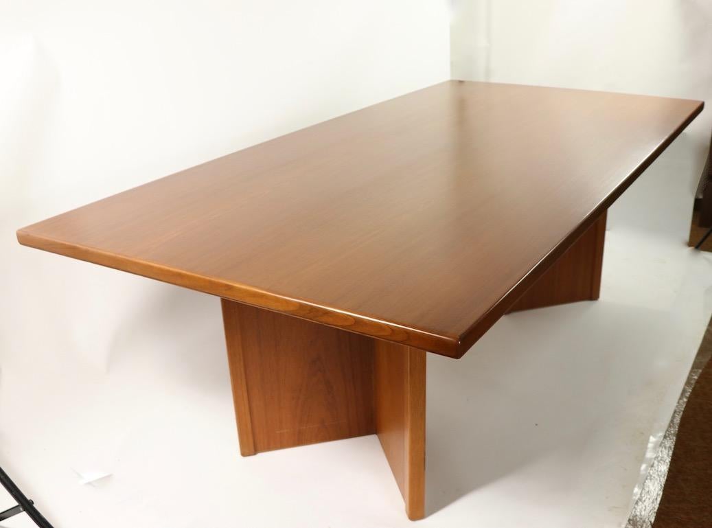 Spectacular conference, or dining table having a solid teak top, and opposing V shaped pedestal legs.
Probably Danish, or possibly Swedish made, this table features a thick (1.25 inch) rectangular top, which has been newly professionally