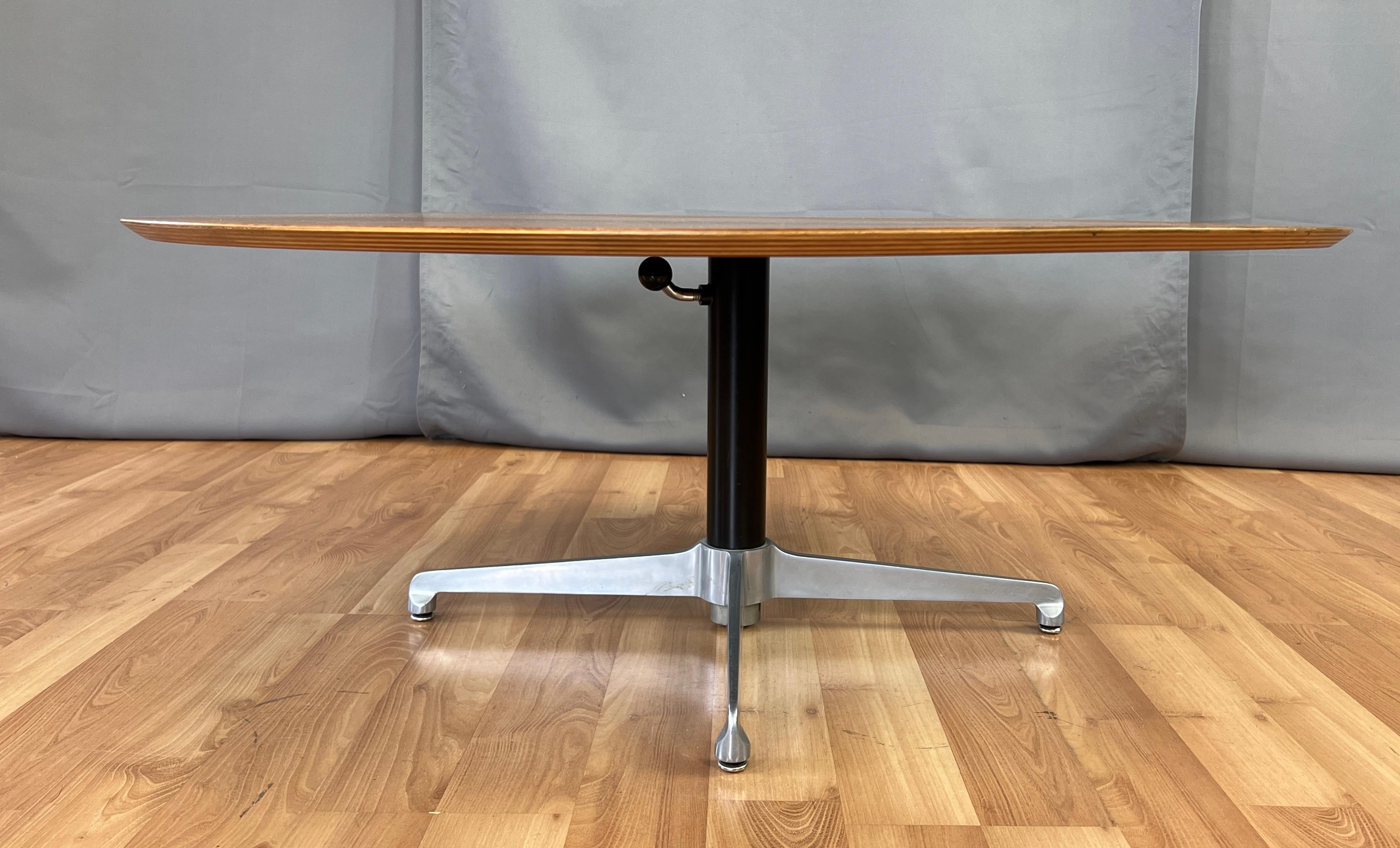 Offered here is a good size Danish modern adjustable height coffee, that also can be used as a dining table, with a four star aluminum base with adjustable glides. Perfect if you don't have the room for both a coffee and dining table.
Round top is