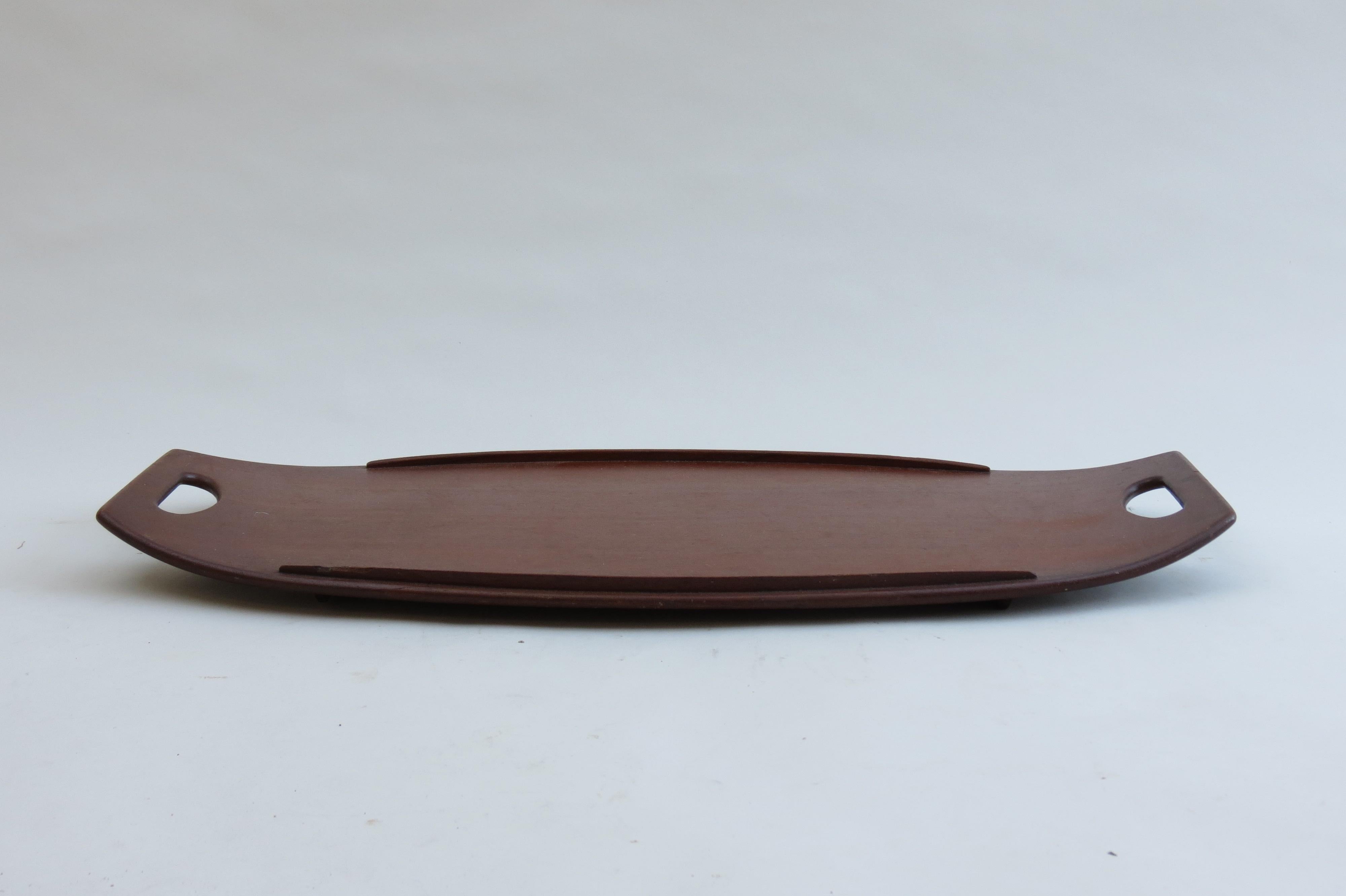 A large Teak tray designed by Jens Quistgaard for Dansk Design, Denmark. Dates from the 1960s.

In good vintage condition, a small amount of loss to one section of the edge of the rim on the tray. 

This piece is stamped to the underside of the