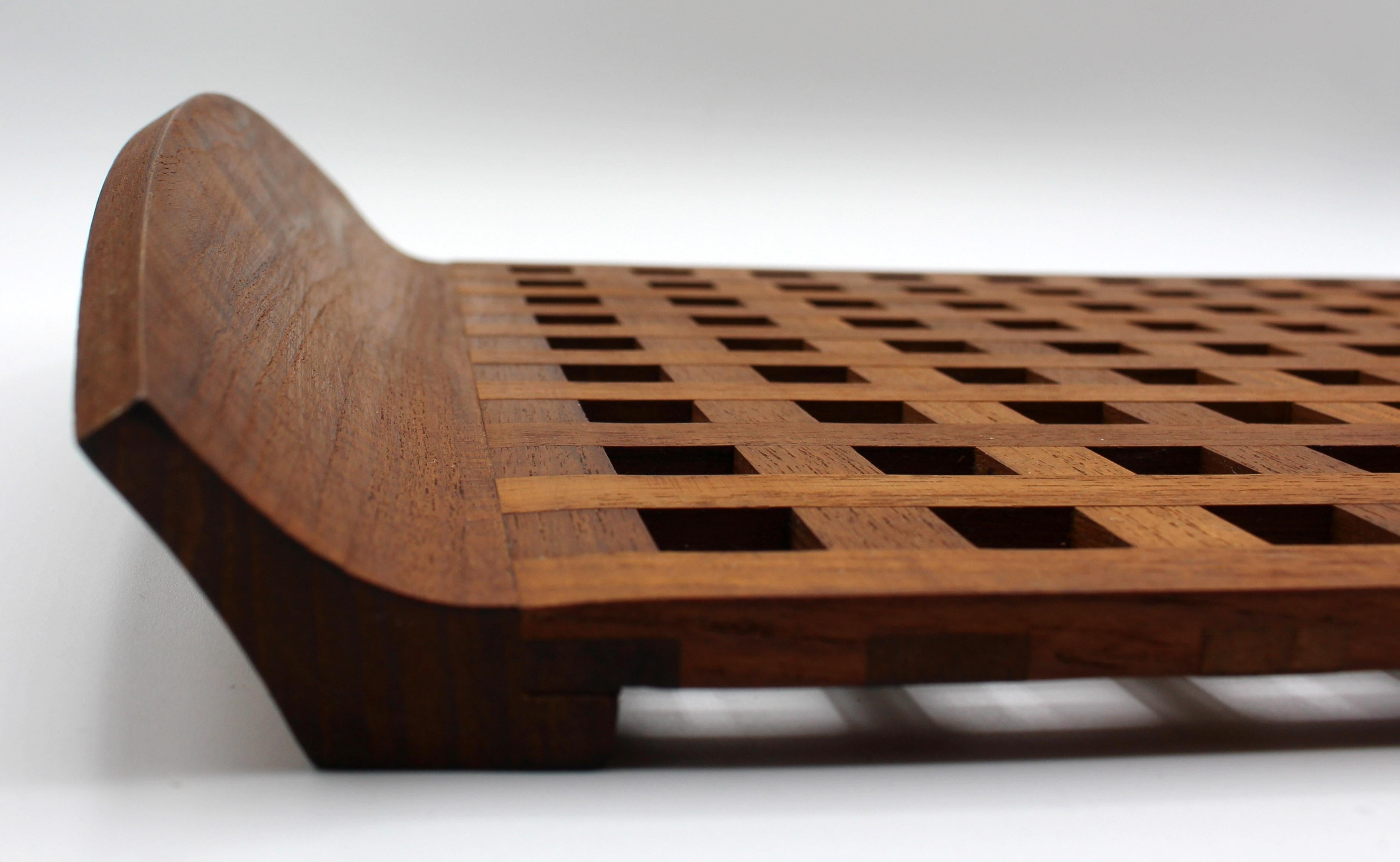 A handsome, large teak lattice work serving tray with outswept sides making secure handles. Integral foot rails. Measures: 18 1/2