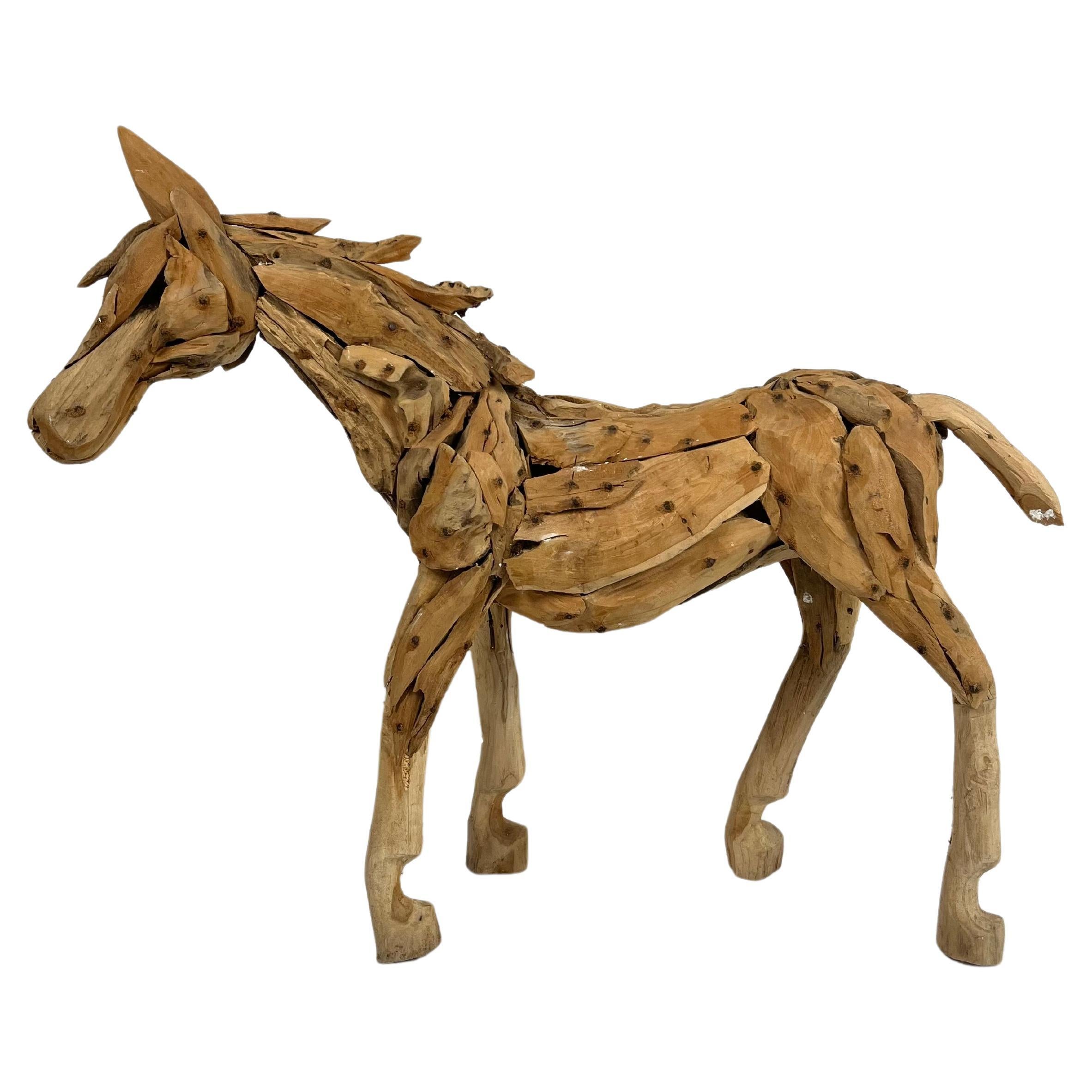 Large teak sculpture of a foal For Sale