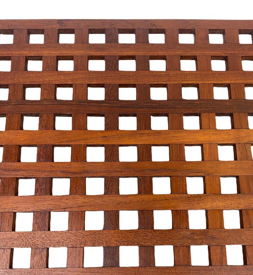 Gorgeous trivet by Dansk and designed by Jens Quistgaard. A classic of Danish modern design, executed in rich teak and made in Denmark (later versions were made in Southeast Asia). Even color throughout with normal wear, has been lightly sanded and
