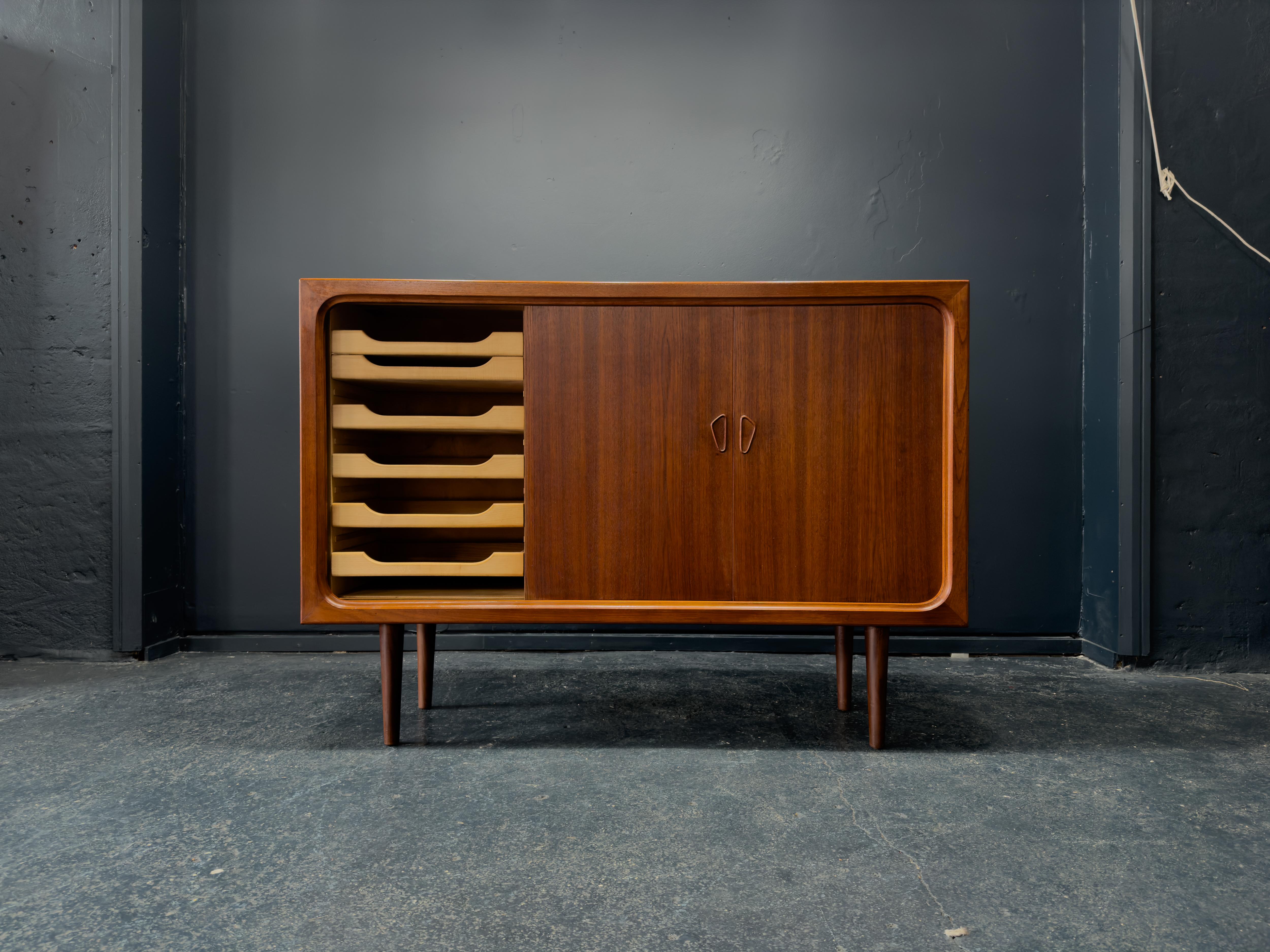 With its unique design features this solid teak sideboard is an incredible statement piece. Danish in origin and dating to the 1960s this piece is a stunning example of midcentury design, each element of this piece has been thought through to not