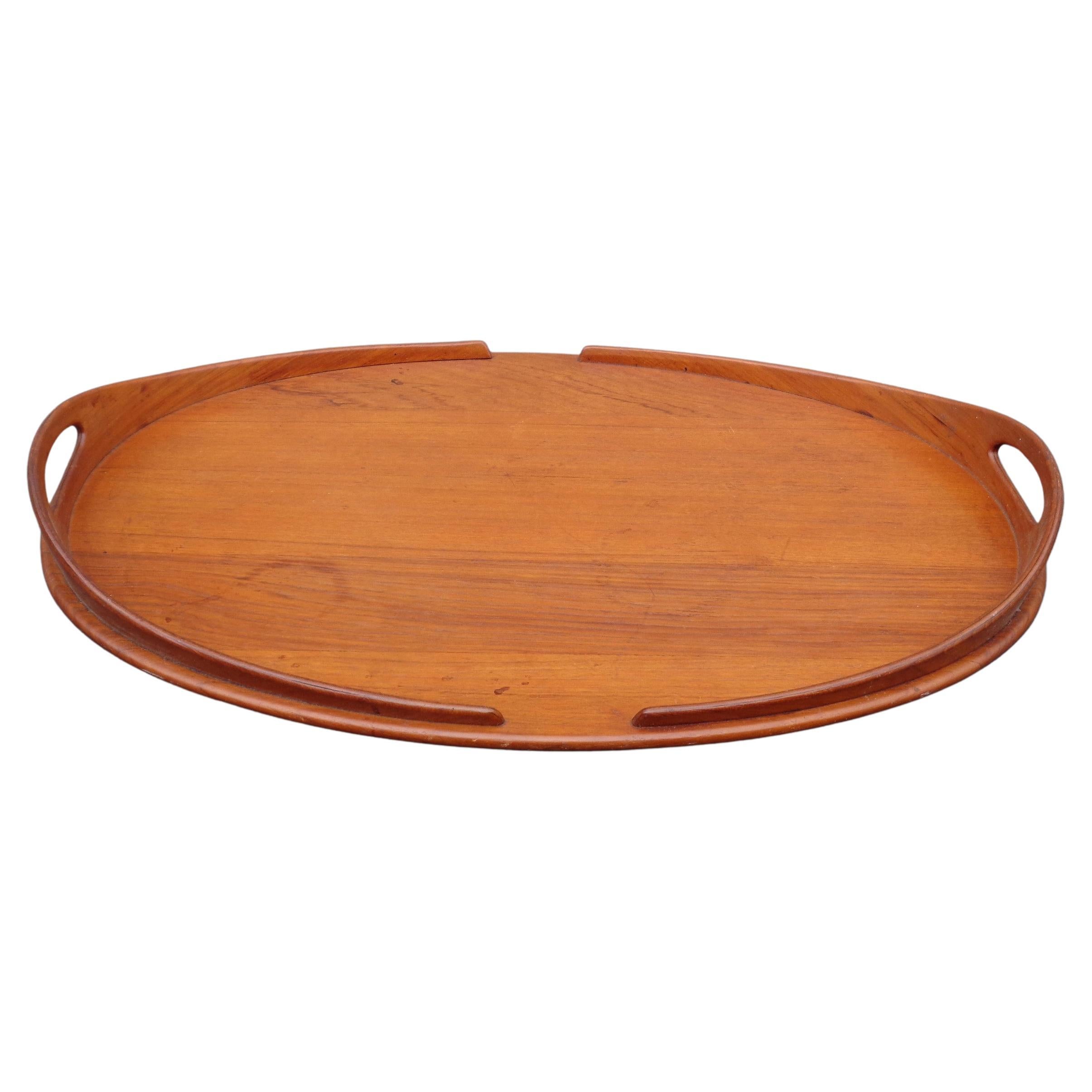 Large sculptural oval teak wood tray by Jens Quistgaard for Dansk, Denmark. Signed underside bottom with early production mark. Overall beautifully aged original glowing color and well figured grain. Circa 1950-1960. Carefully look at all pictures